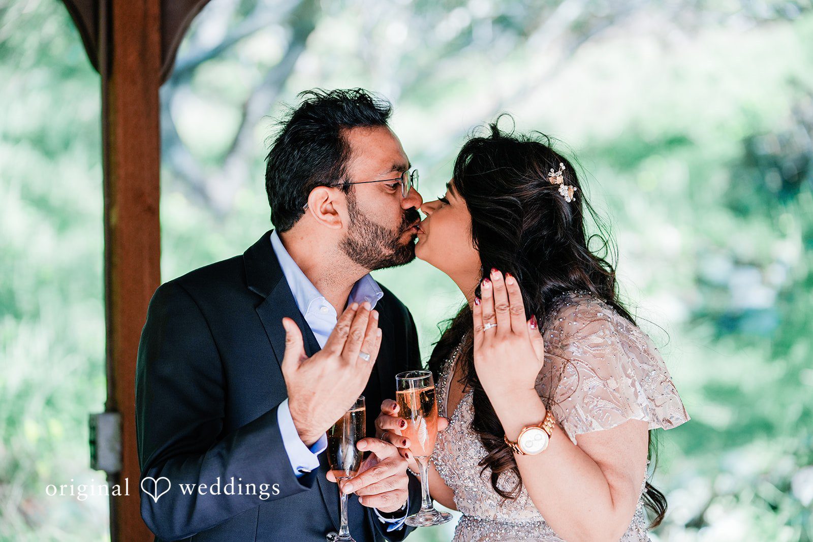 Romantic pose of couple showing their wedding rings