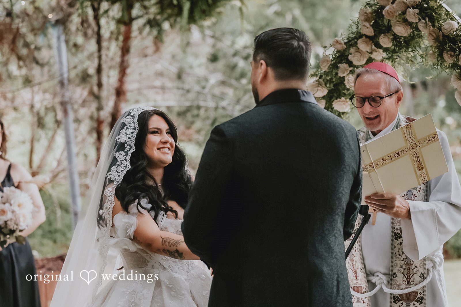 Bride looking at groom happily during ceremony
