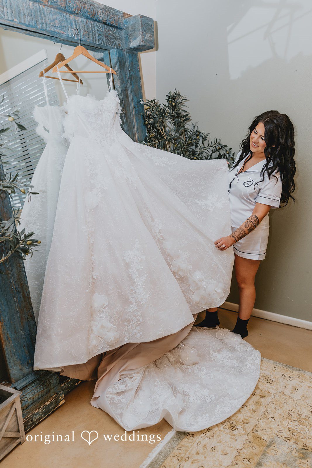 Bride admiring her wedding gown