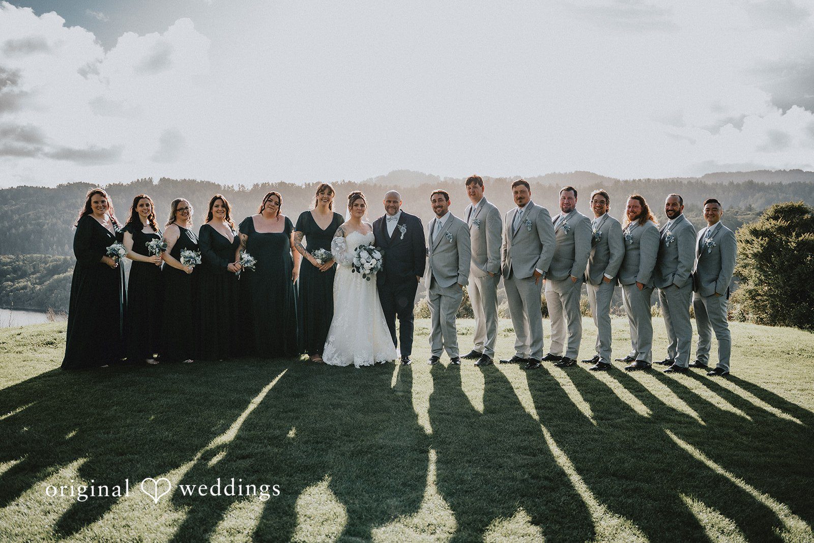 Dominique + Chris Bride and groom posing with bridesmaids and groomsmen together