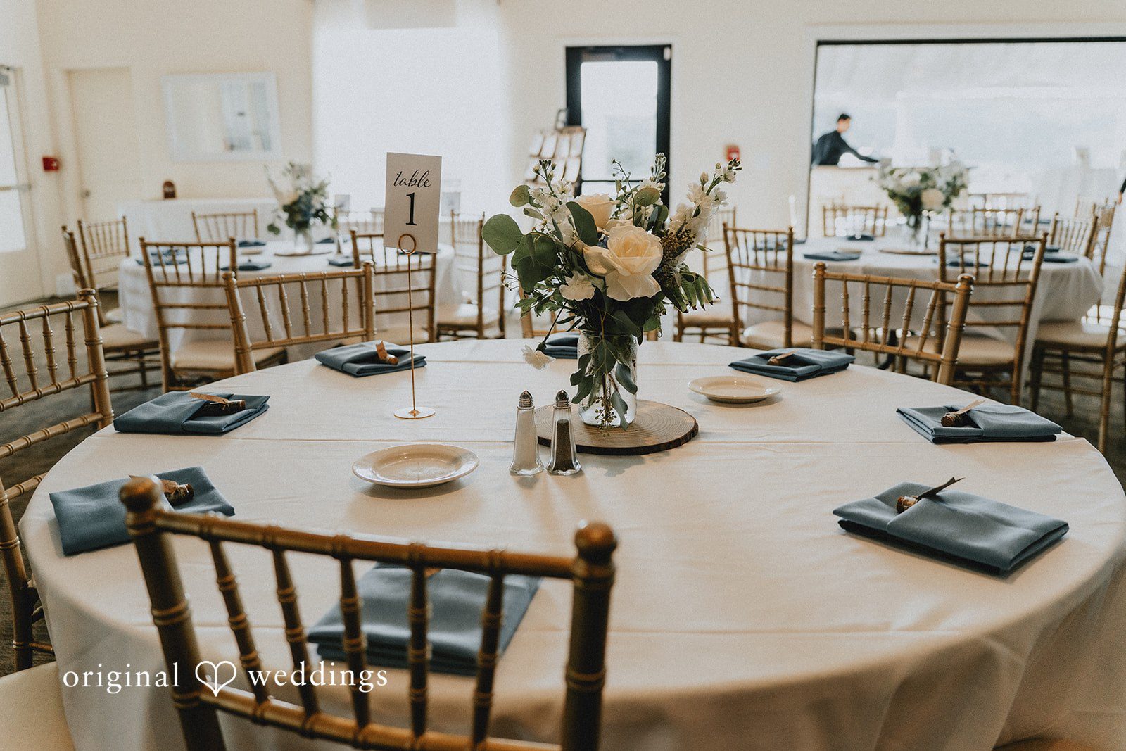 Dominique + Chris Reception tables decorated with floral centerpieces and candles