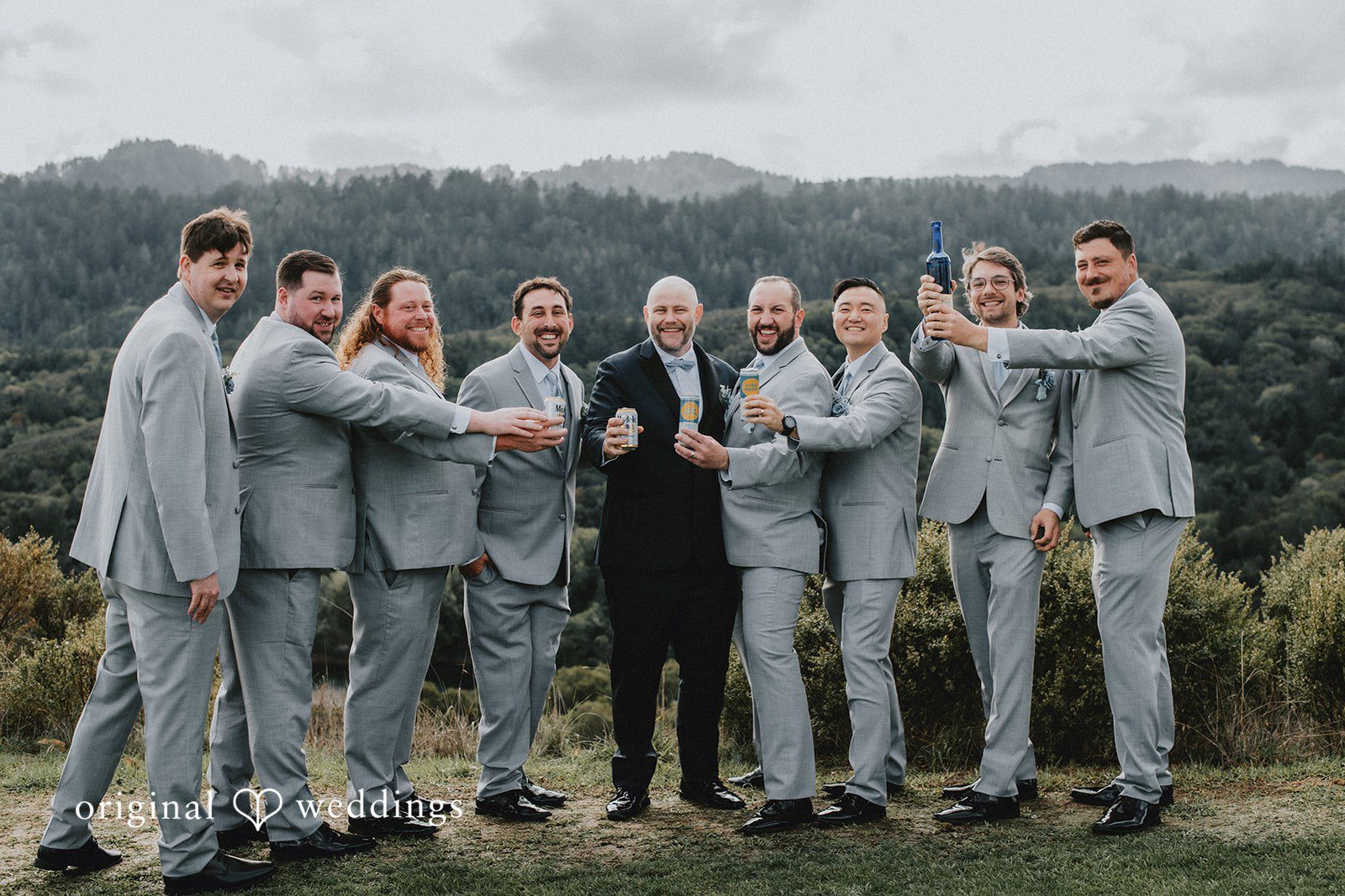 Dominique + Chris Groom posing with groomsmen outside the venue