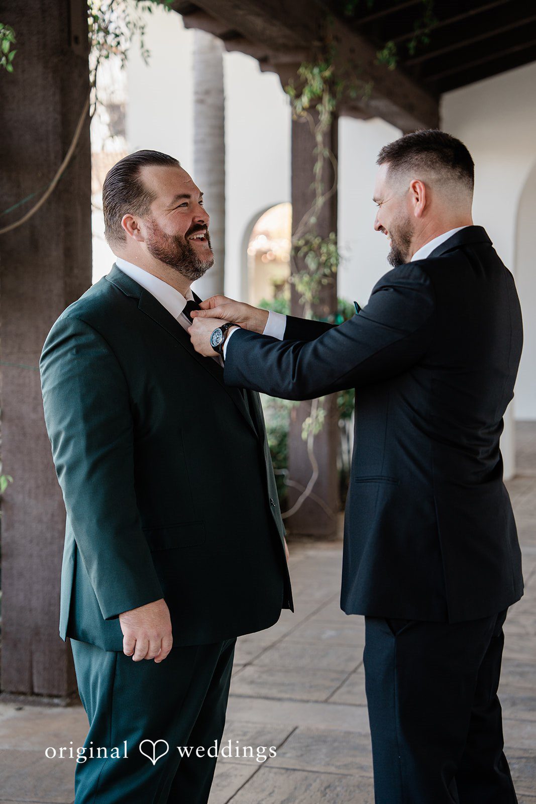 Jinelle + Brett Groom getting ready while adjusting his suit before ceremony