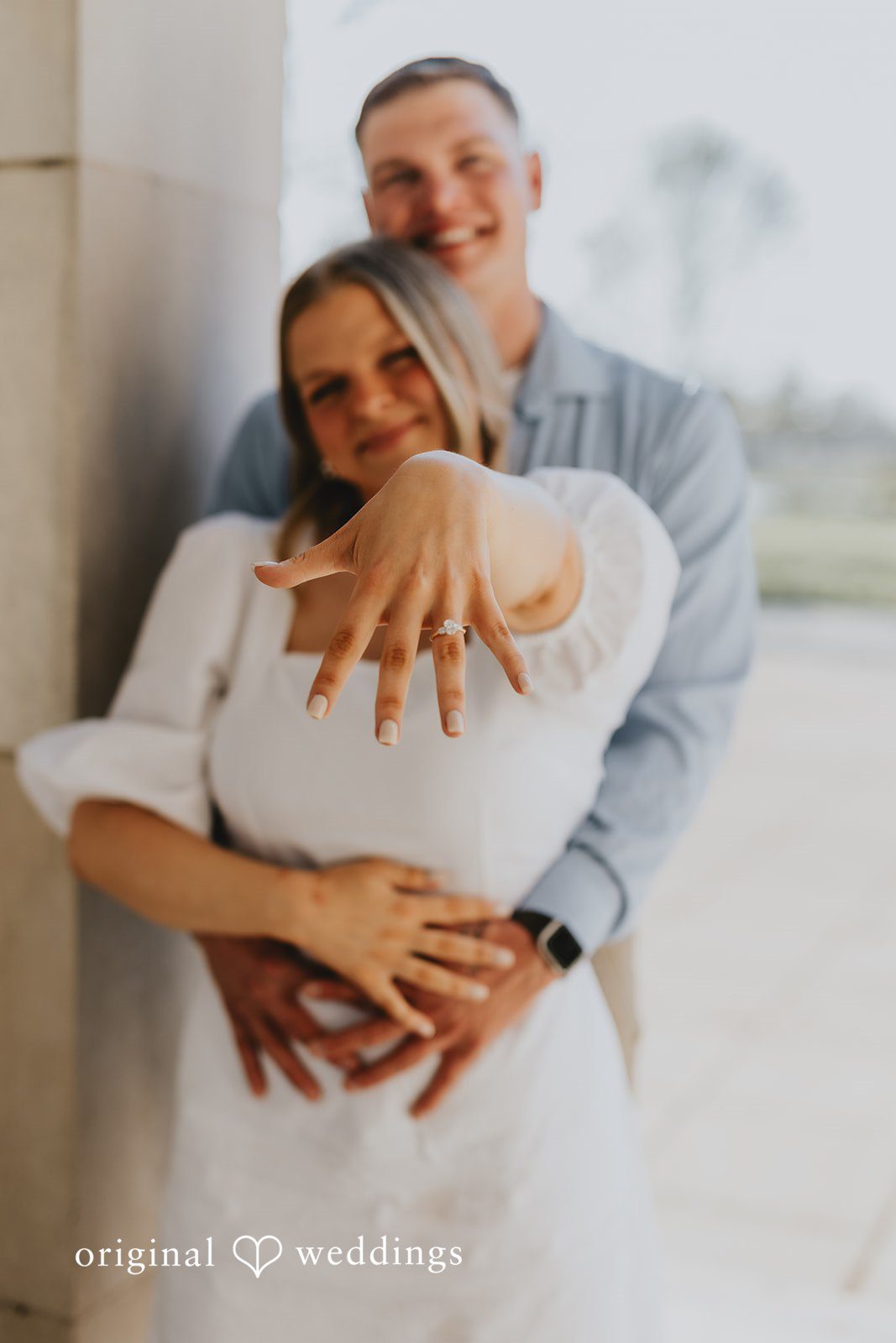 The bride shows off her engagement ring