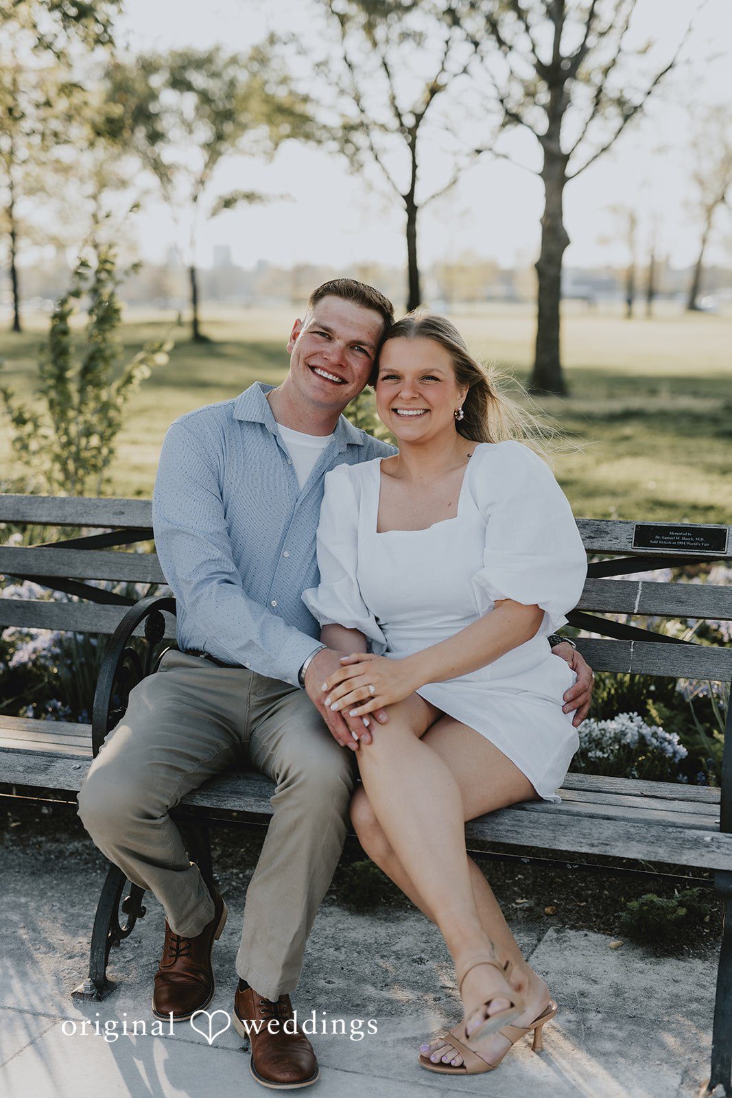 The couple takes a seated portrait at Forest Park