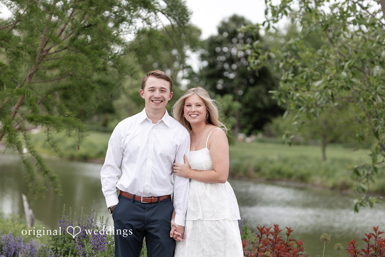 Rhyen + Jacob Couple posing together among tall grass during the engagement session