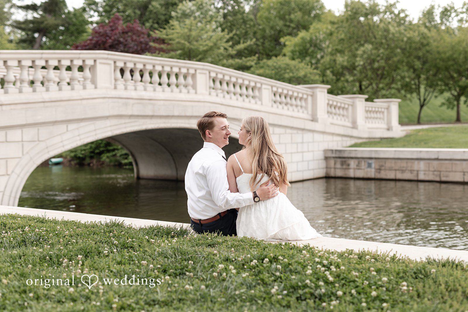 Rhyen + Jacob Couple standing beside the bridge with their backs facing the camera