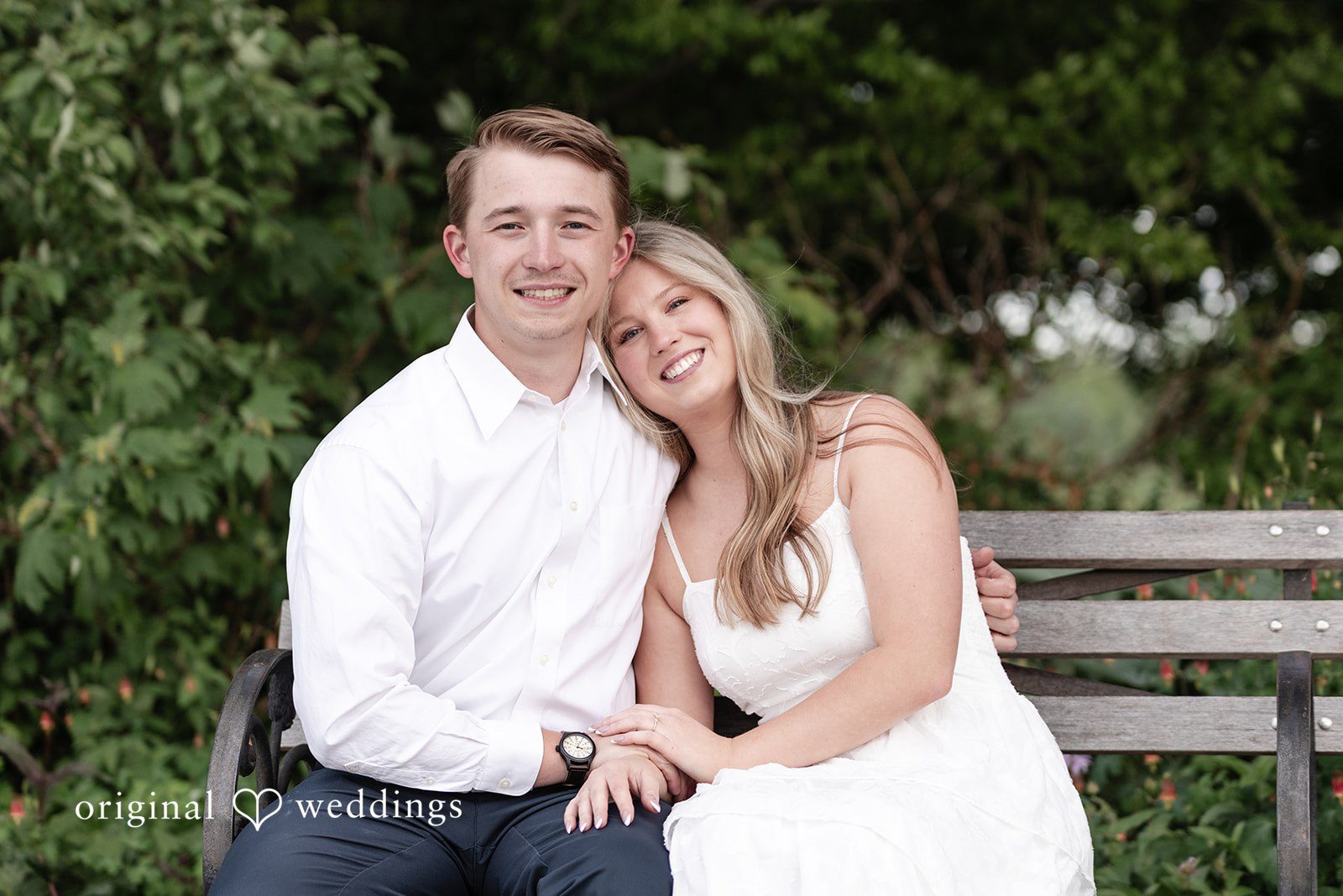 Rhyen + Jacob Couple sitting together on a bench during the engagement session