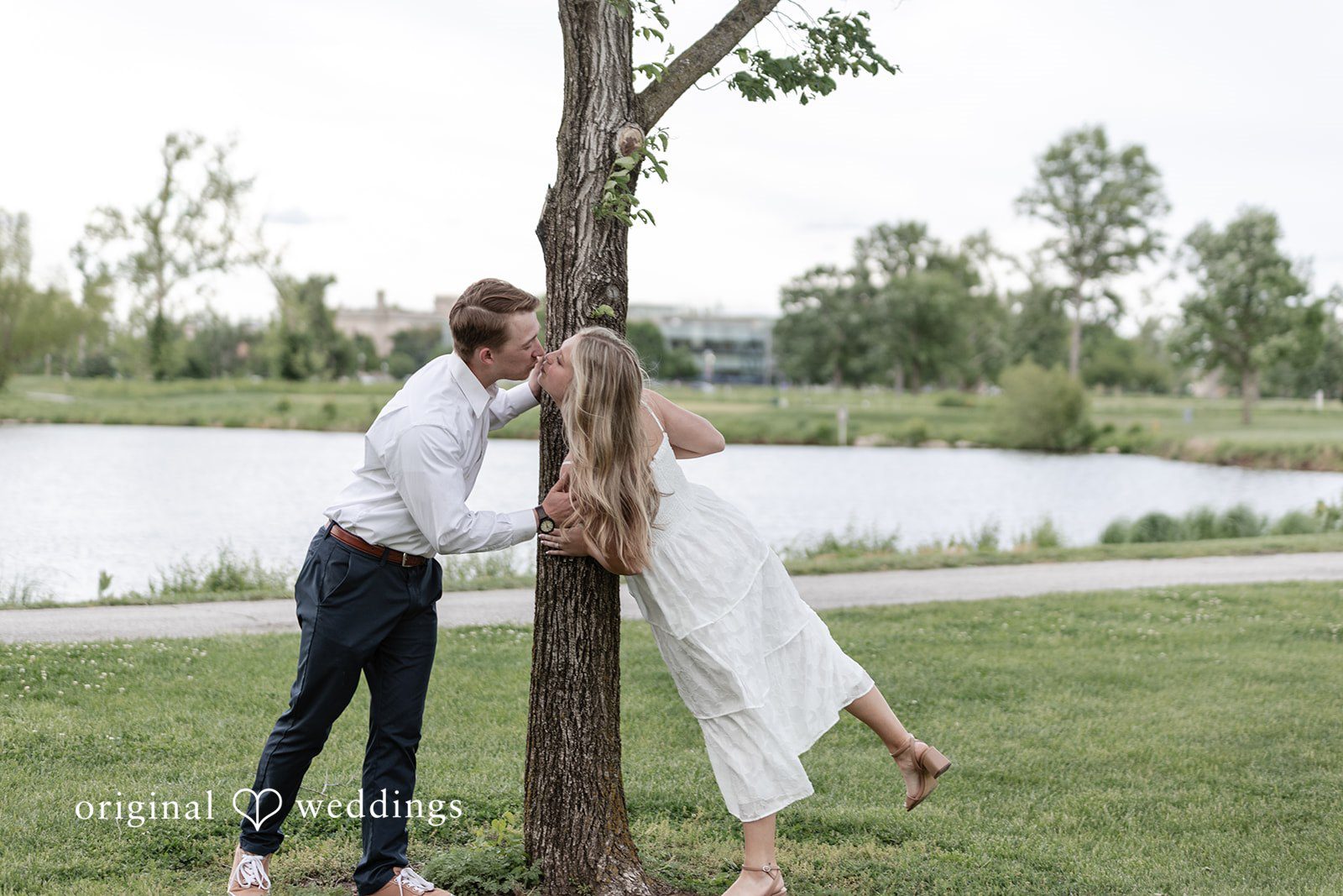 Rhyen + Jacob Couple playing together near a tree during engagement photos