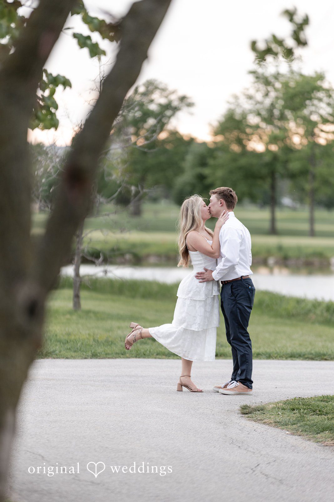 Rhyen + Jacob Couple kissing outdoors beneath the sunset sky during engagement photos