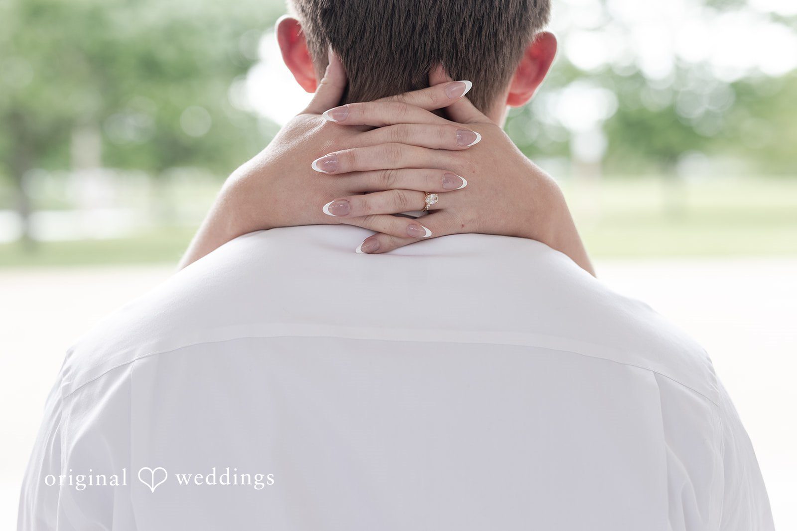 Rhyen + Jacob Bride holding onto the groom’s back while showing her engagement ring