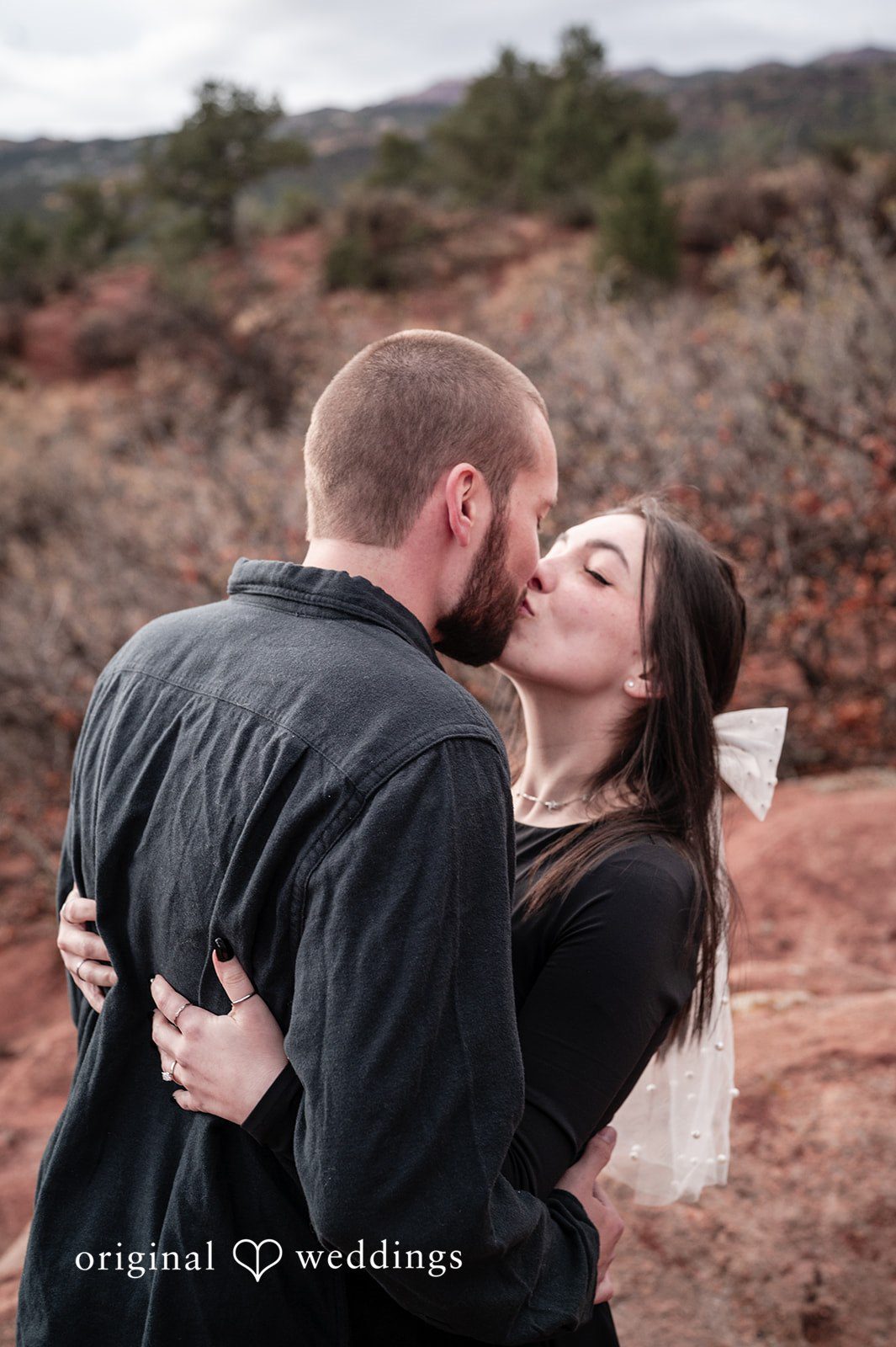 The couple shares a passionate kiss