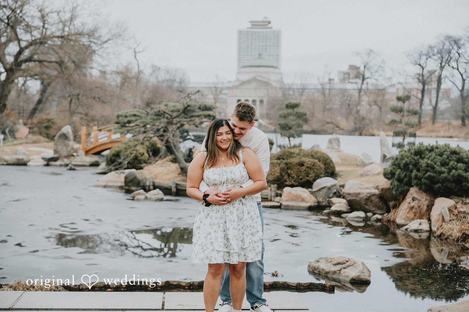 Couple standing close by the water sharing a romantic moment.