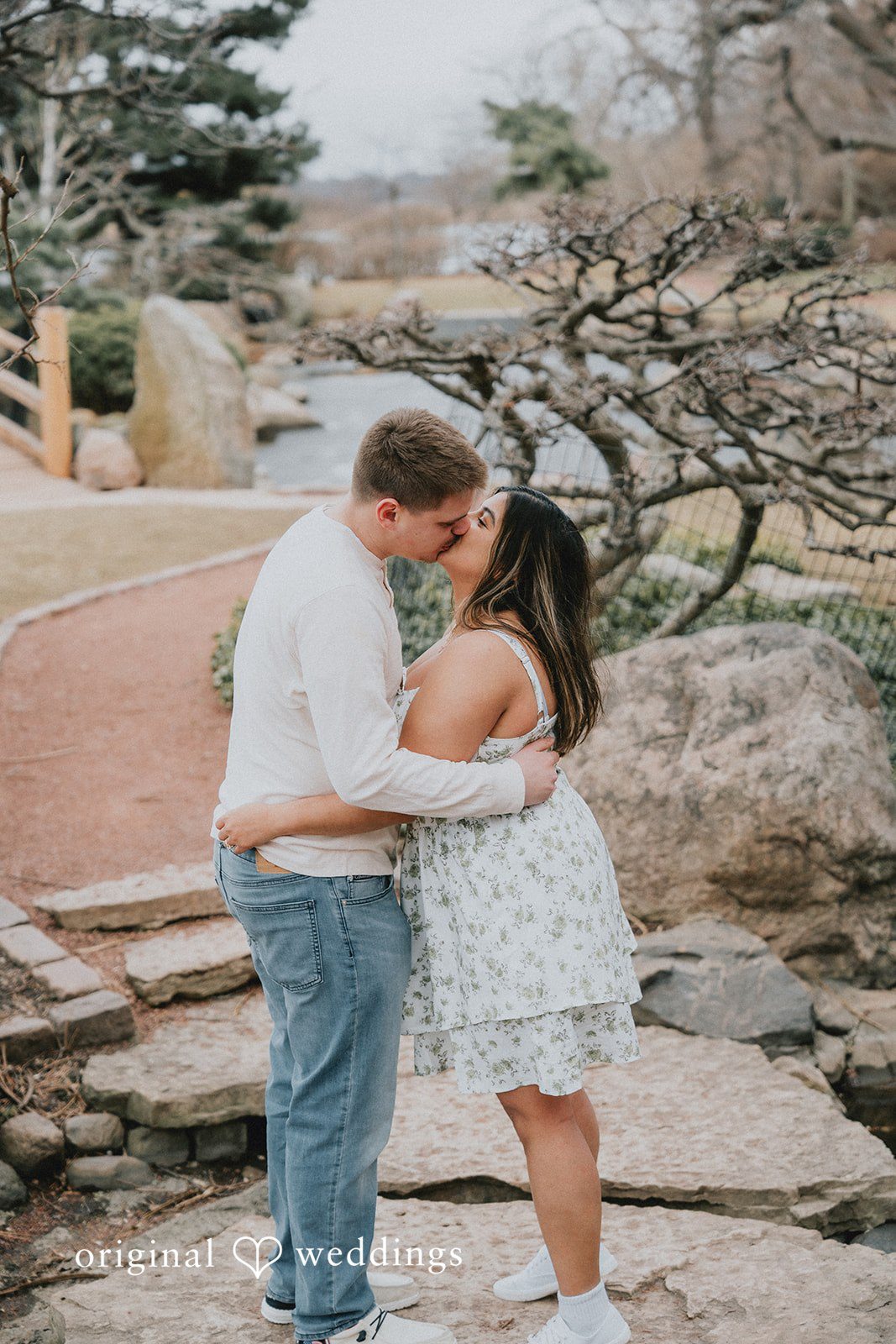 Couple sharing a joyful kiss while holding each other.
