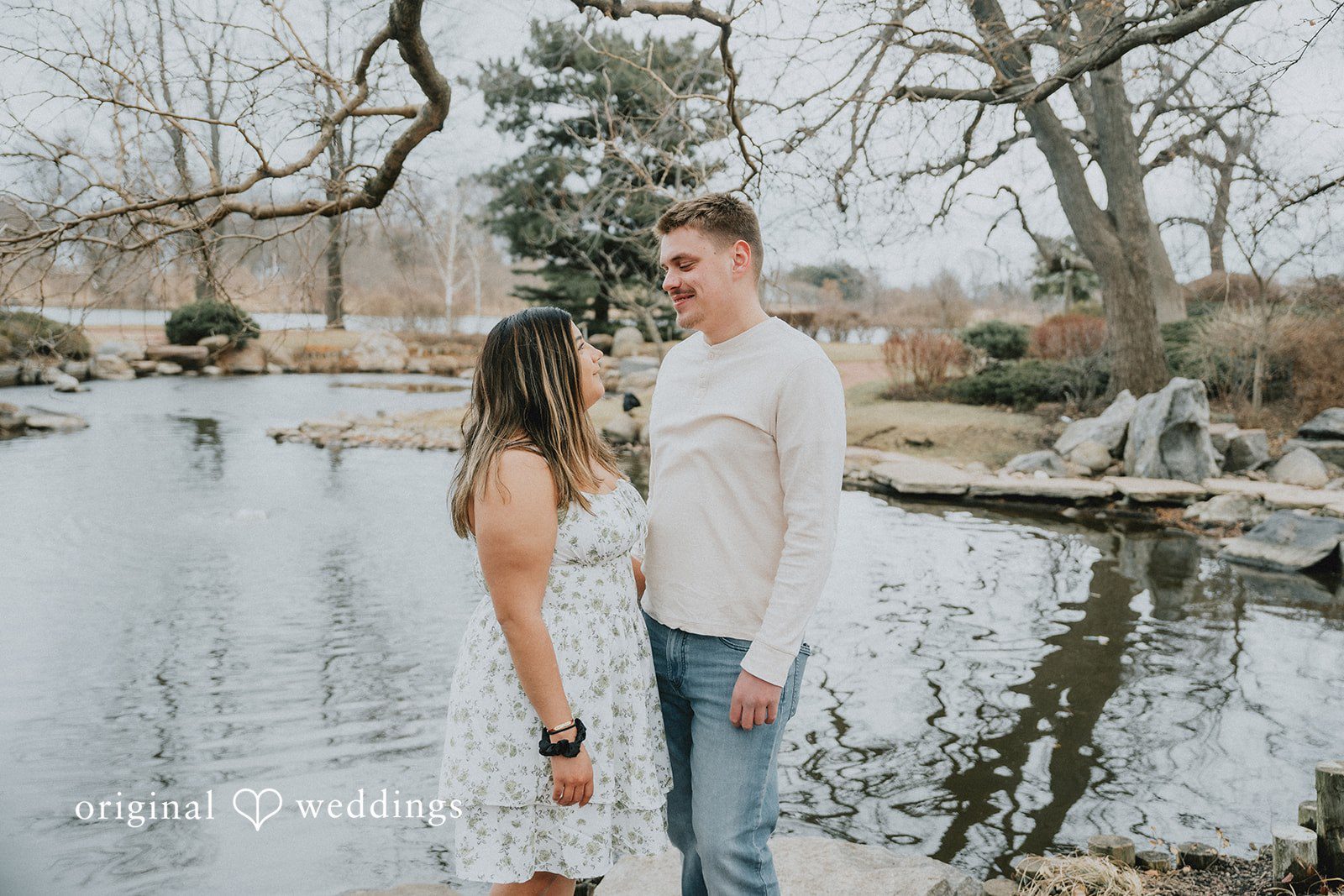Couple standing together looking at each other.