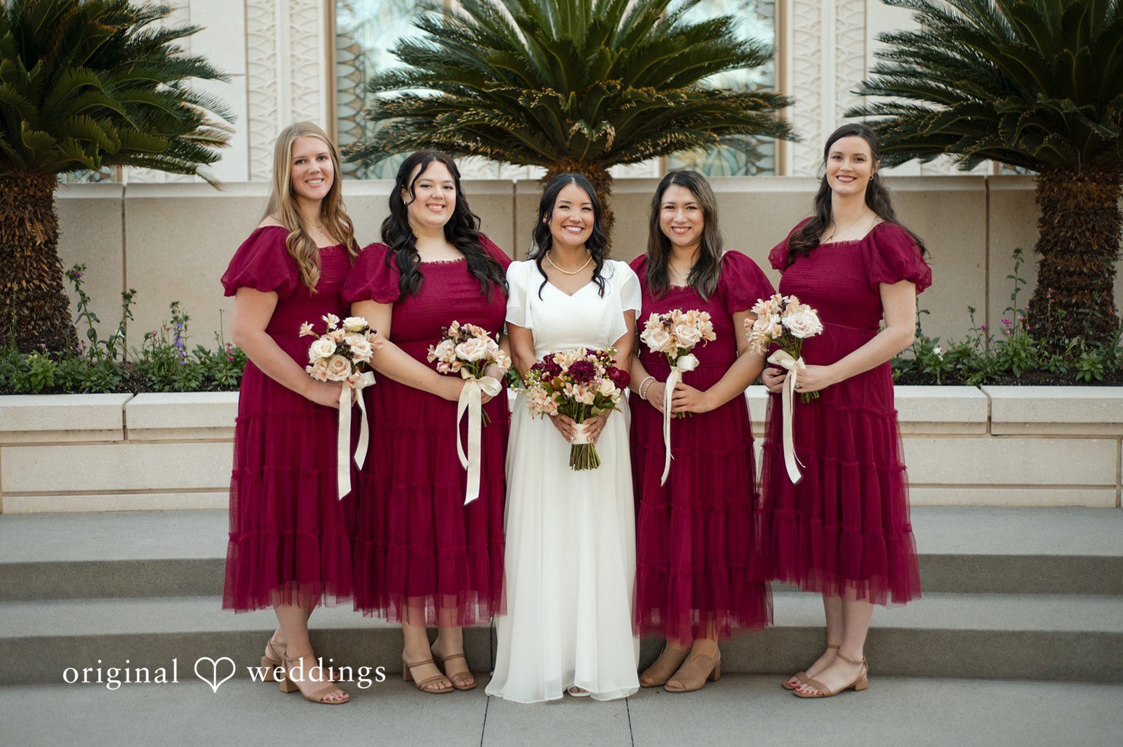 Bride posing with bridesmaids before the ceremony