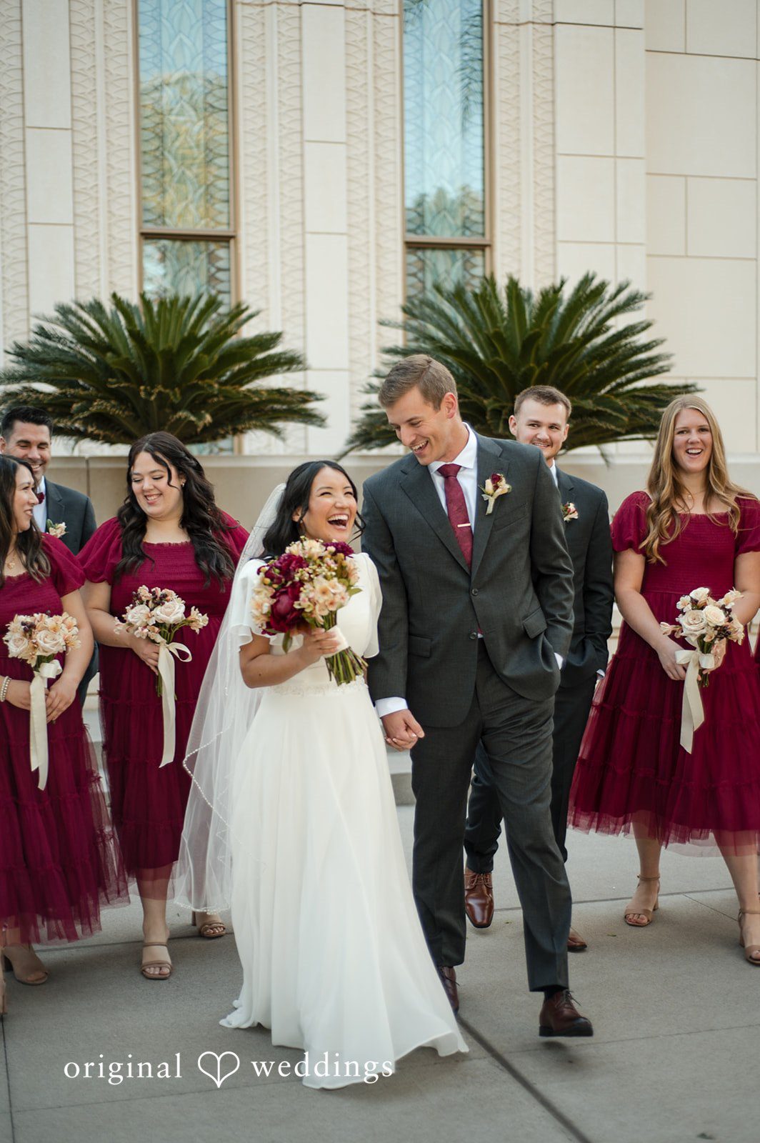 Bride and groom standing behind the bridesmaids during wedding portraits