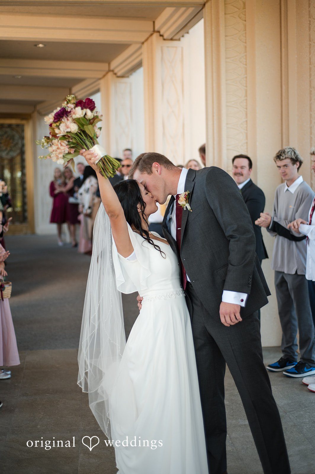 Couple sharing a kiss before heading to the ceremony
