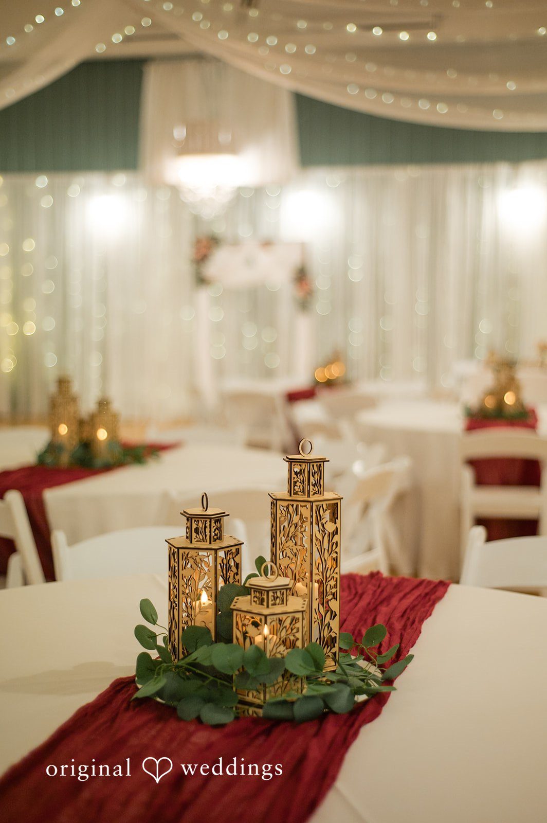 Reception guest tables styled with candles and floral centerpieces