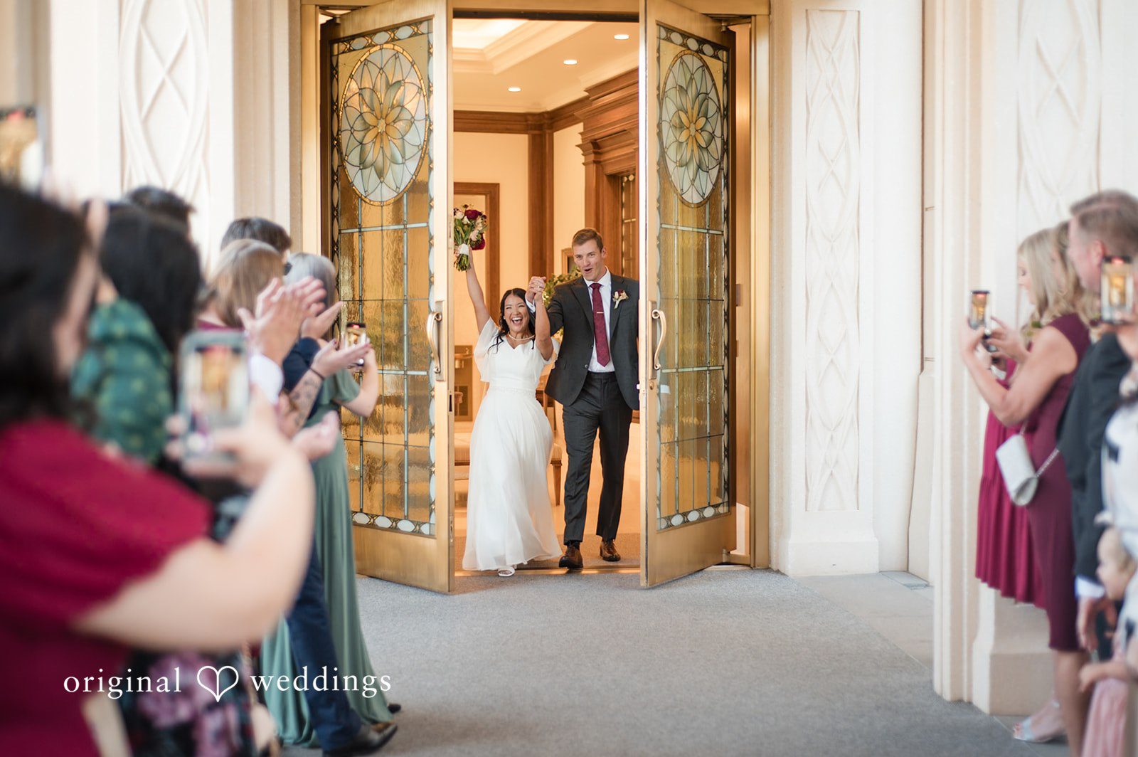 Bride and groom greeting guests during their reception entrance