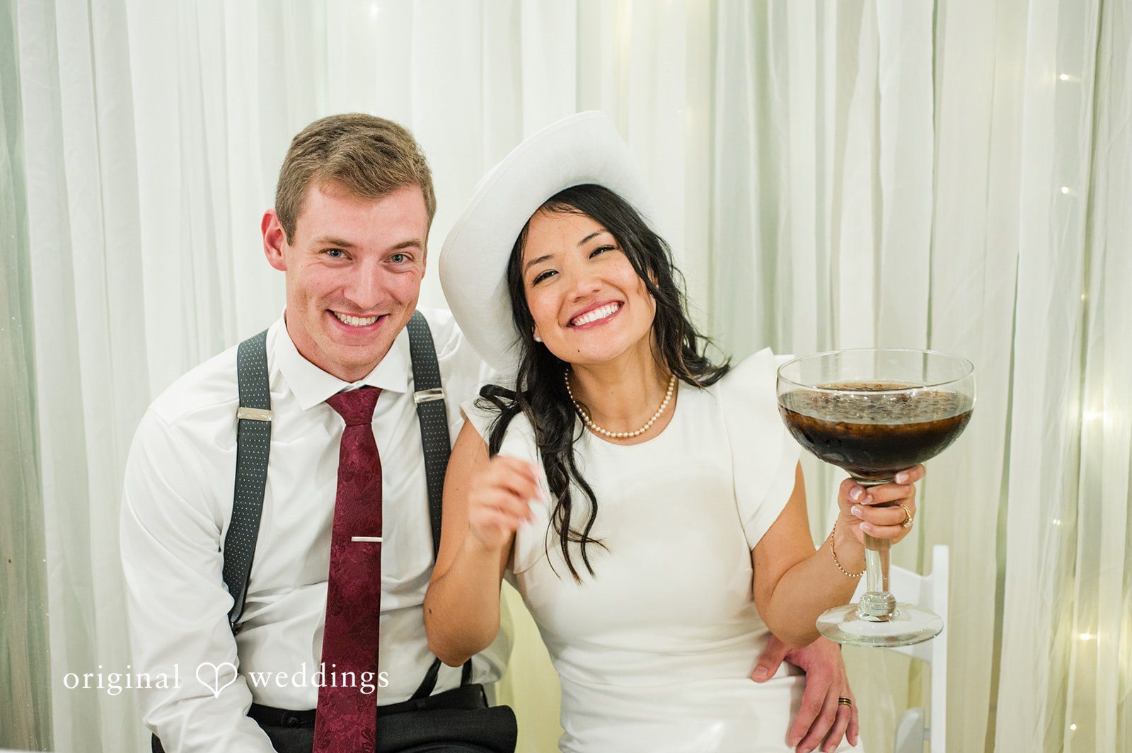 Bride and groom enjoying drinks together during the reception