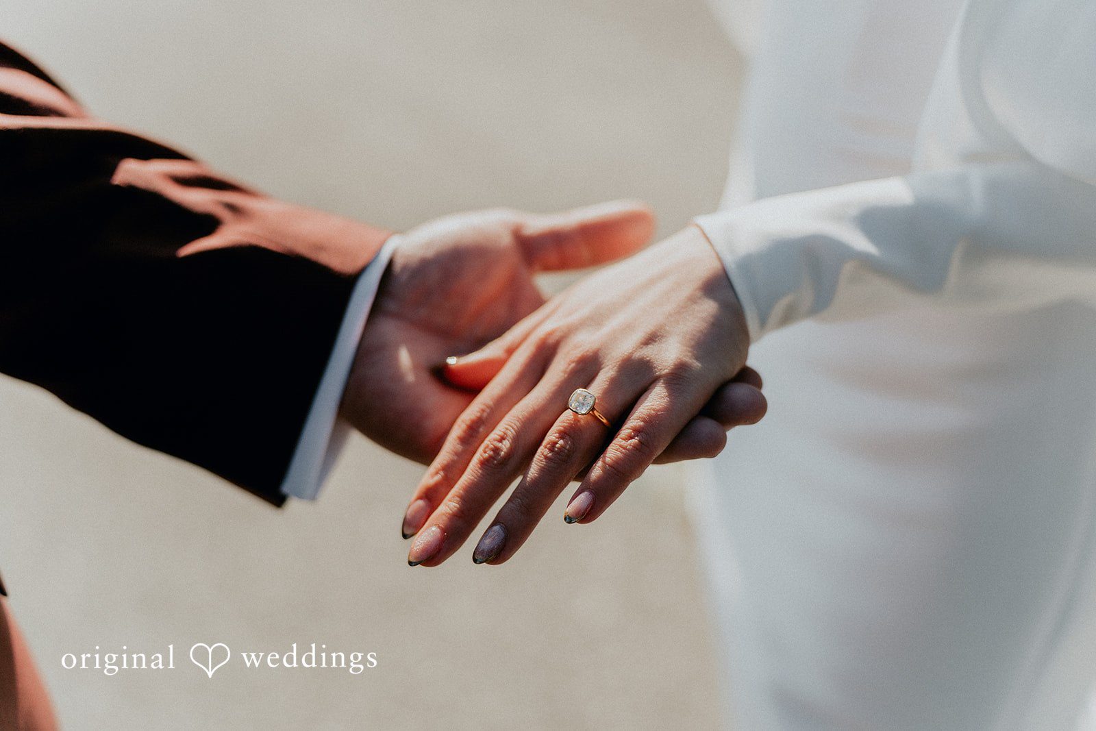 A close-up shot of the couple's hands
