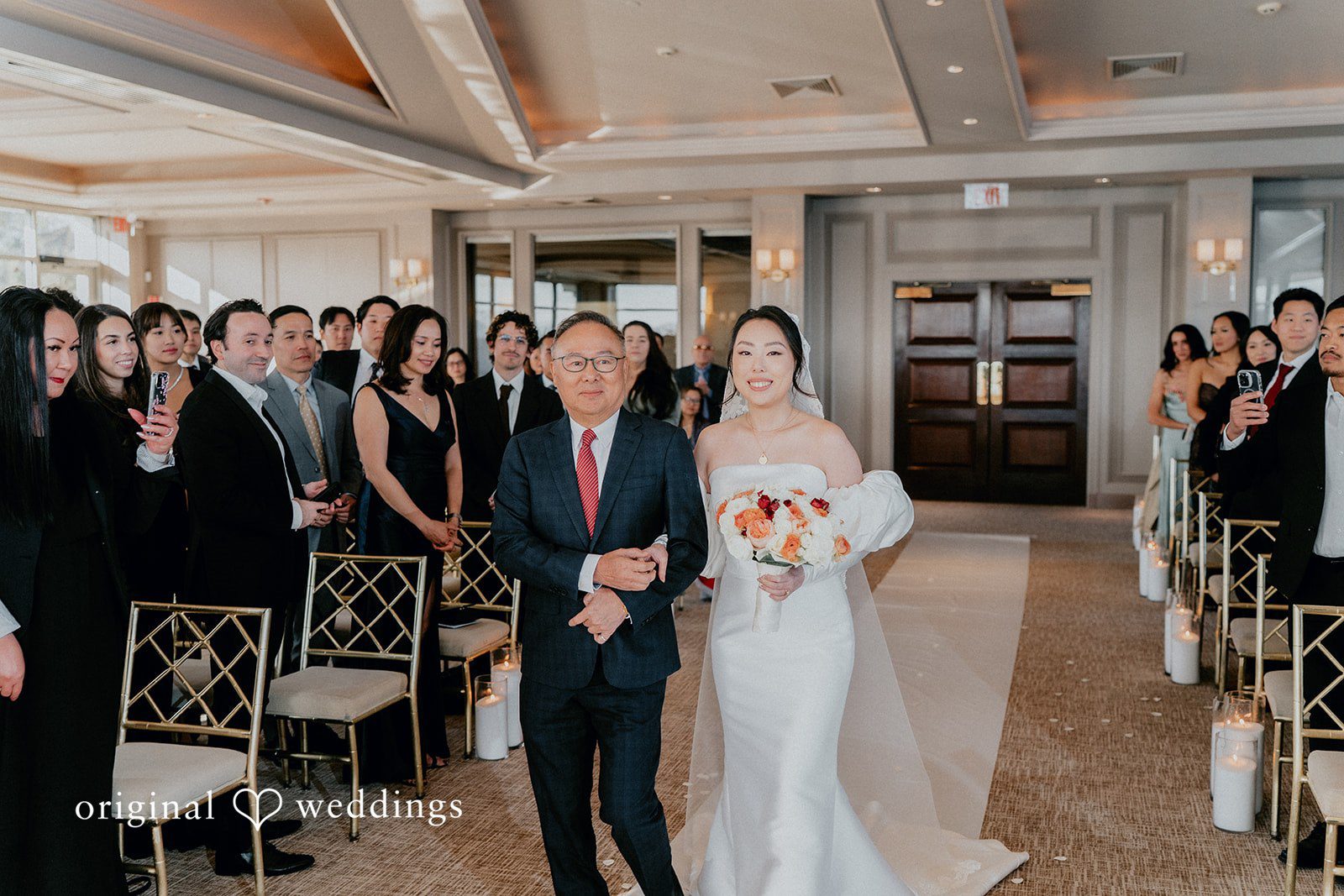 The bride's father walks bride down the aisle