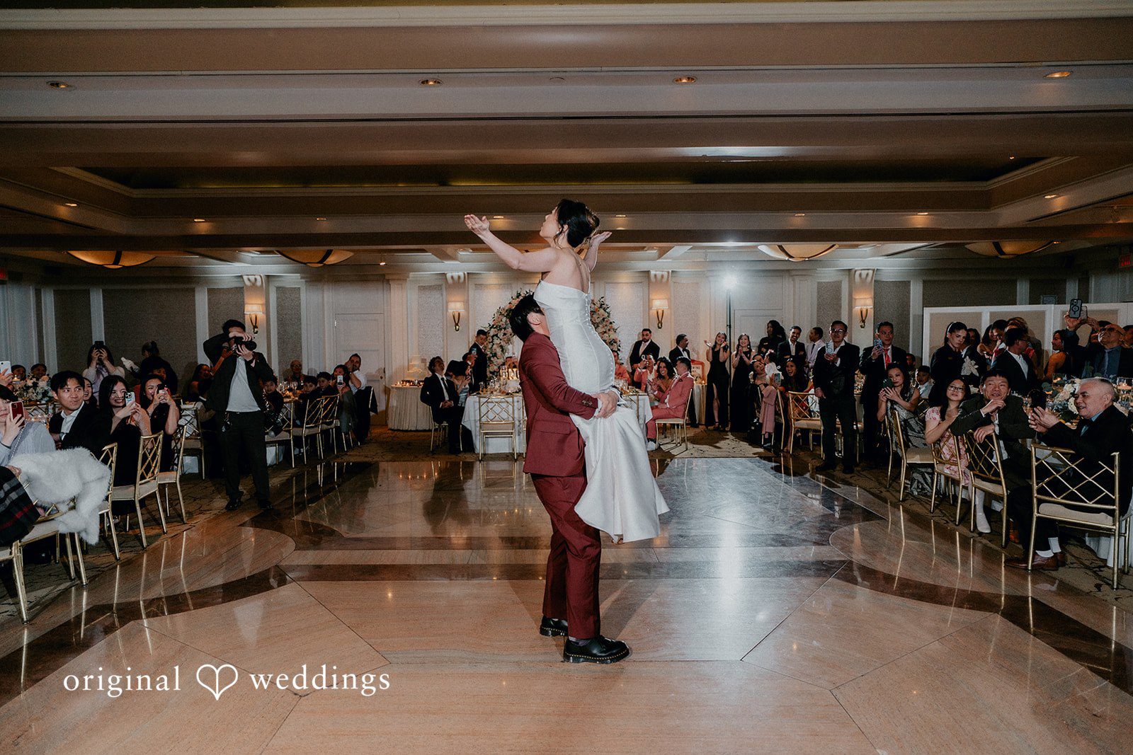 The couple having a fun time at their wedding reception