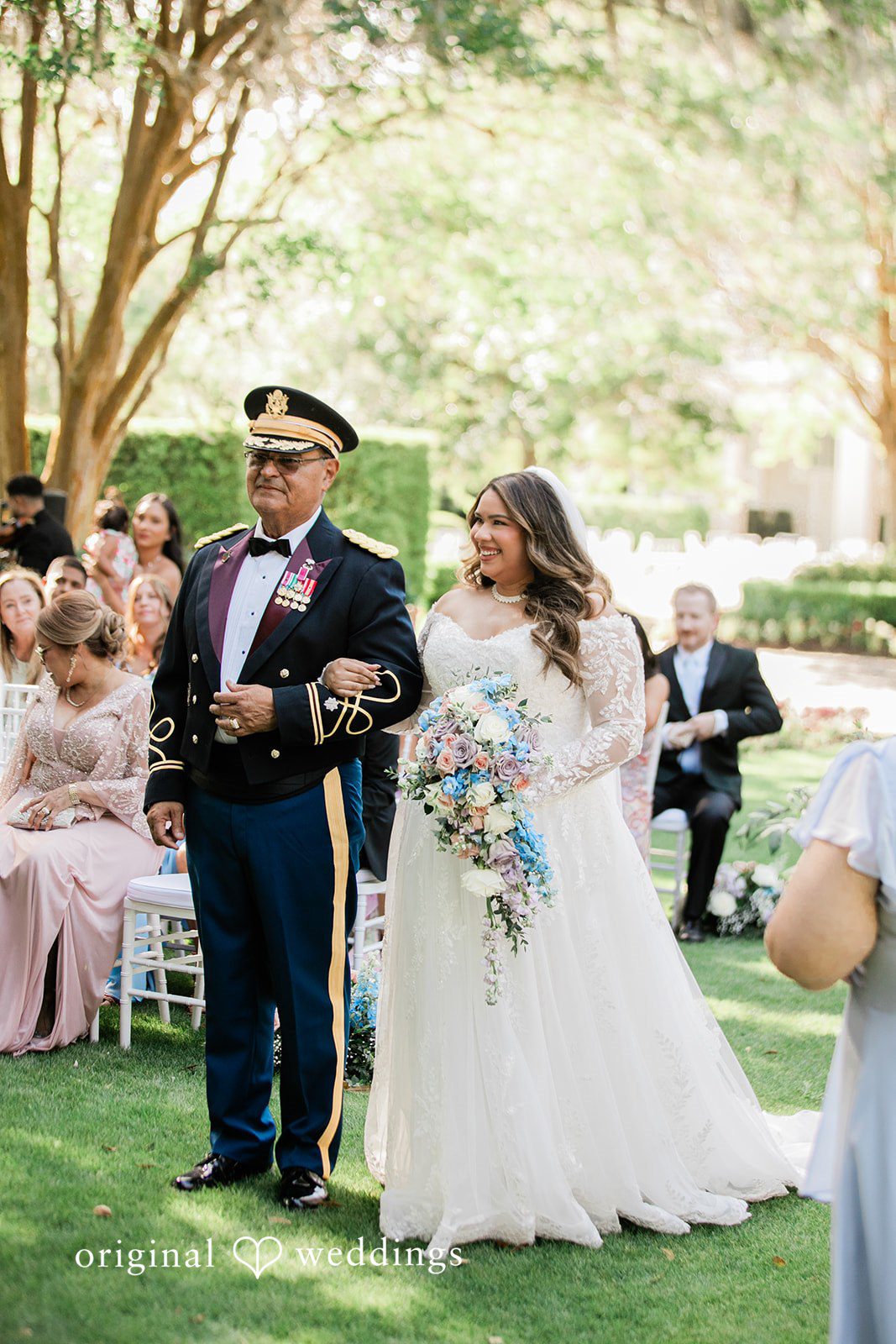 The bride's father walks the bride down the aisle