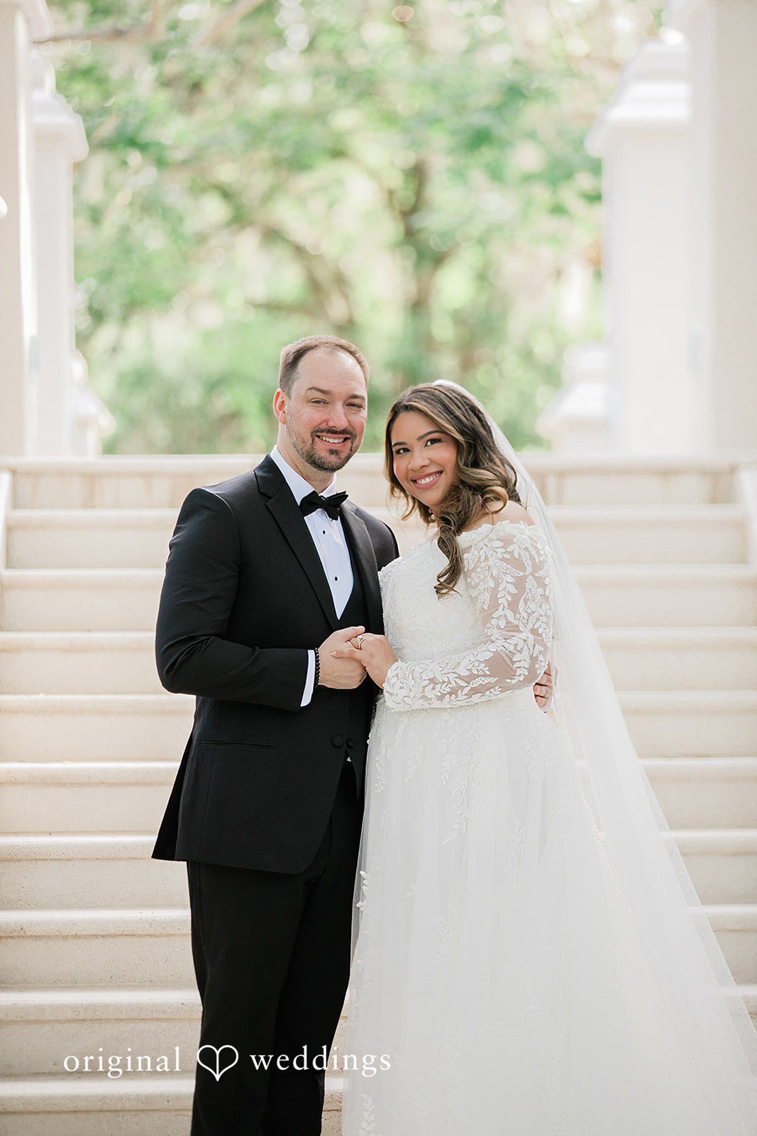 A gorgeous portrait of the couple by the stairs at the wedding venue
