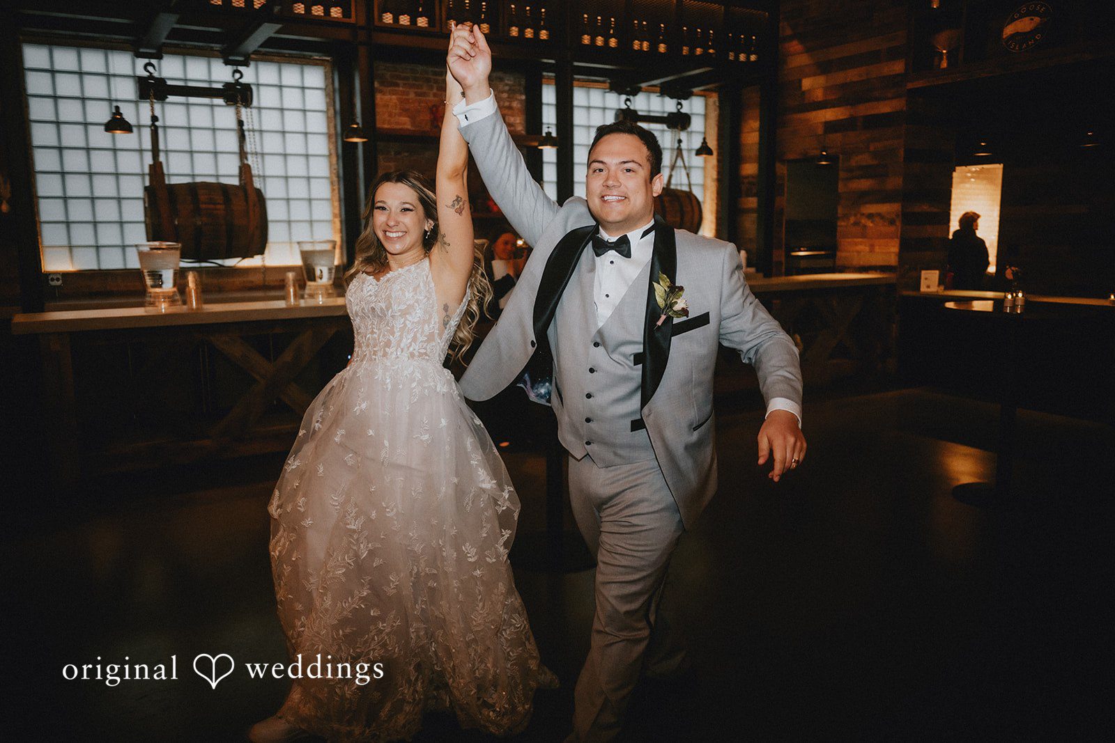 The couple makes a joyful entrance to their wedding reception