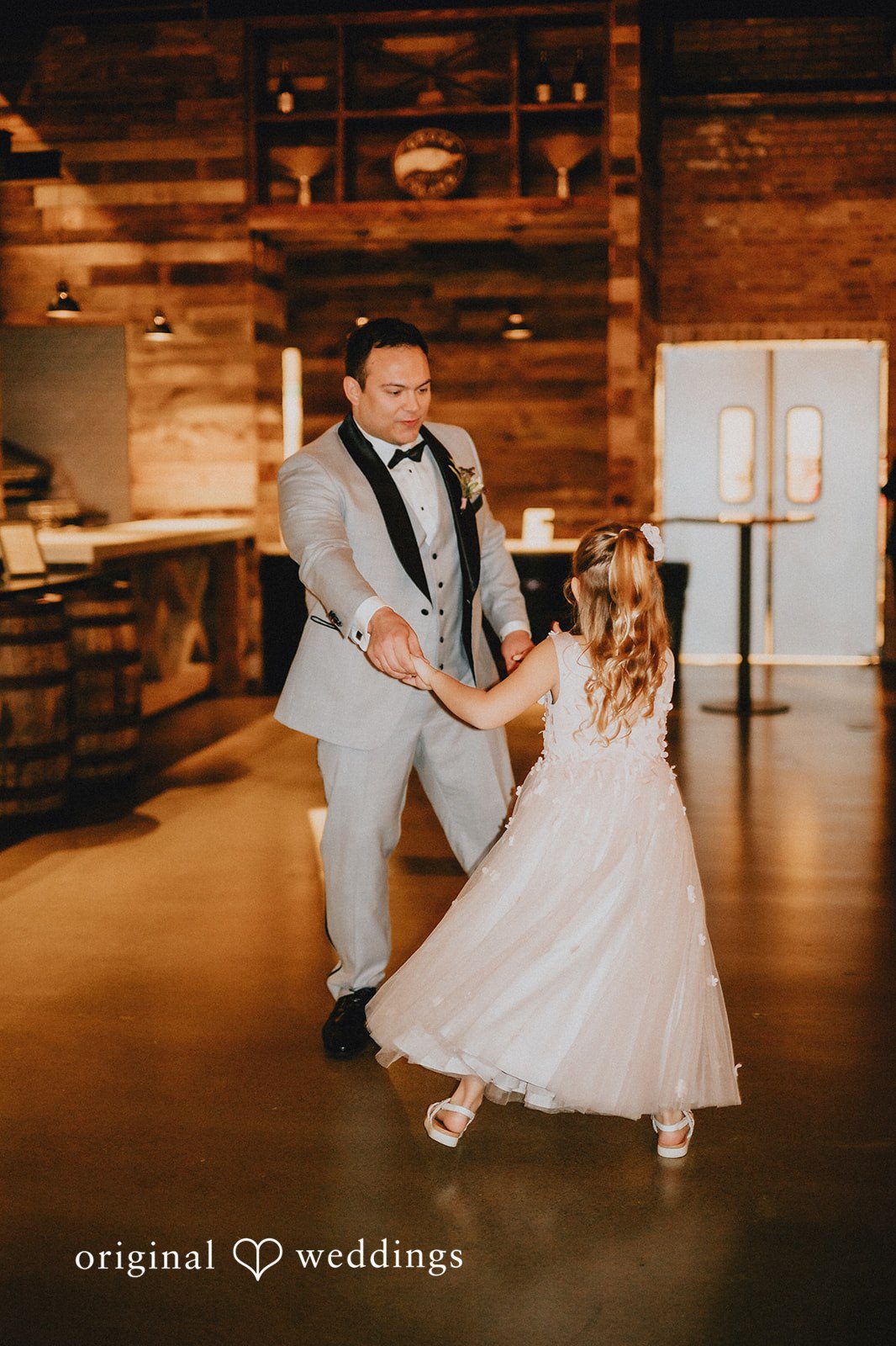 The groom dances with the kid