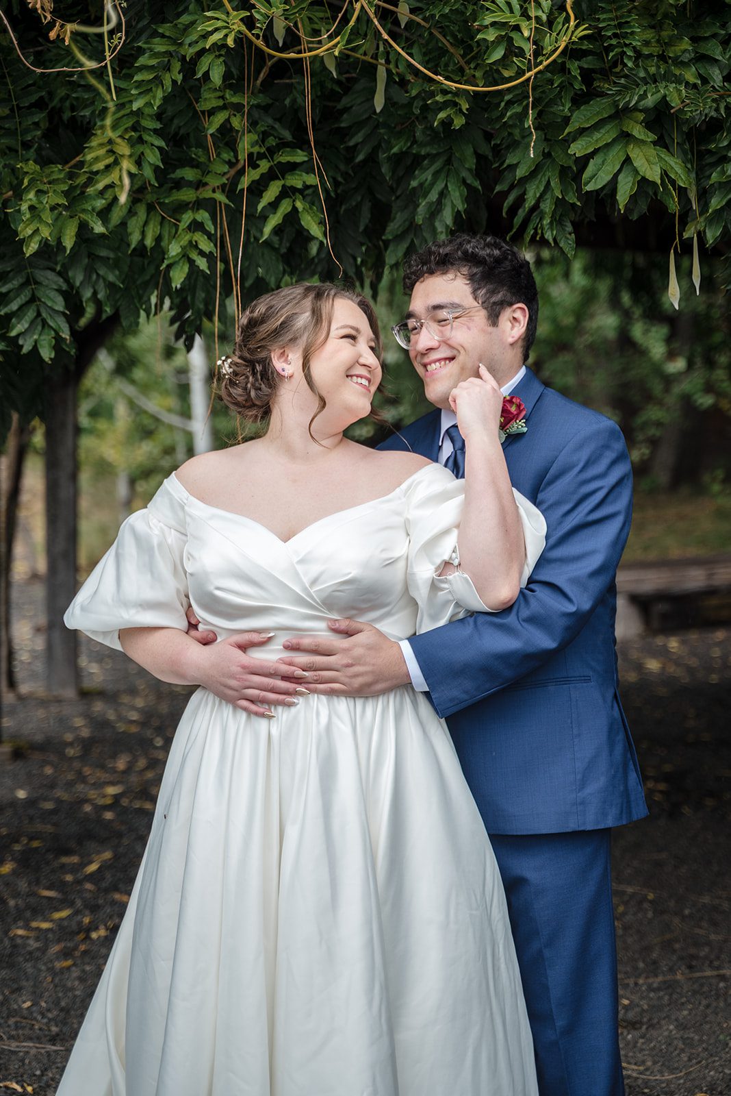 Tiare + Jeremy Romantic wedding portrait featuring bride and groom smiling at each other