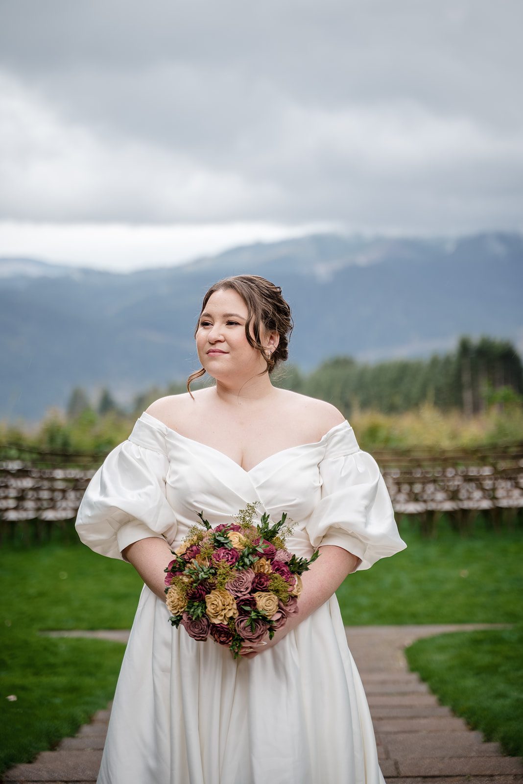 Tiare + Jeremy Elegant bride holding romantic floral bouquet at Gorge Crest Vineyards