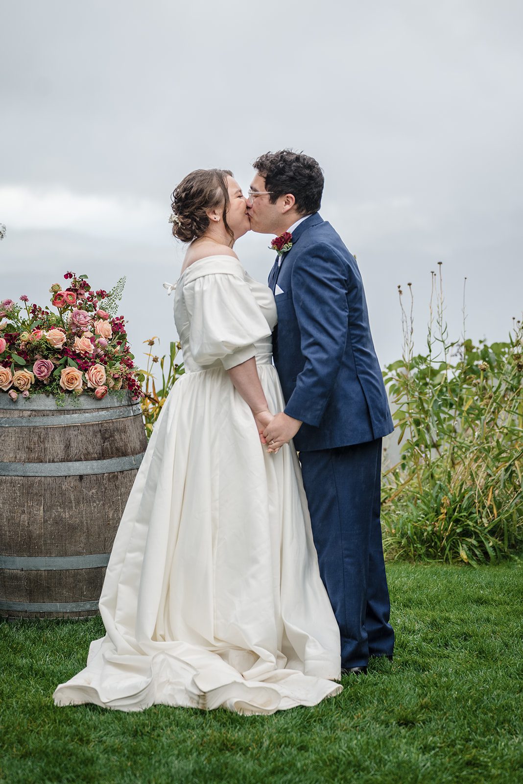 Tiare + Jeremy Romantic moment of bride and groom kissing after wedding ceremony