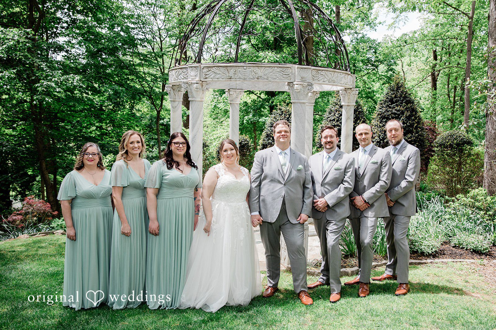 Nicole + Greg Our Baltimore wedding photographers captured a stunning portrait of the couple and their bridal party at the Gramercy Mansion Carriage House