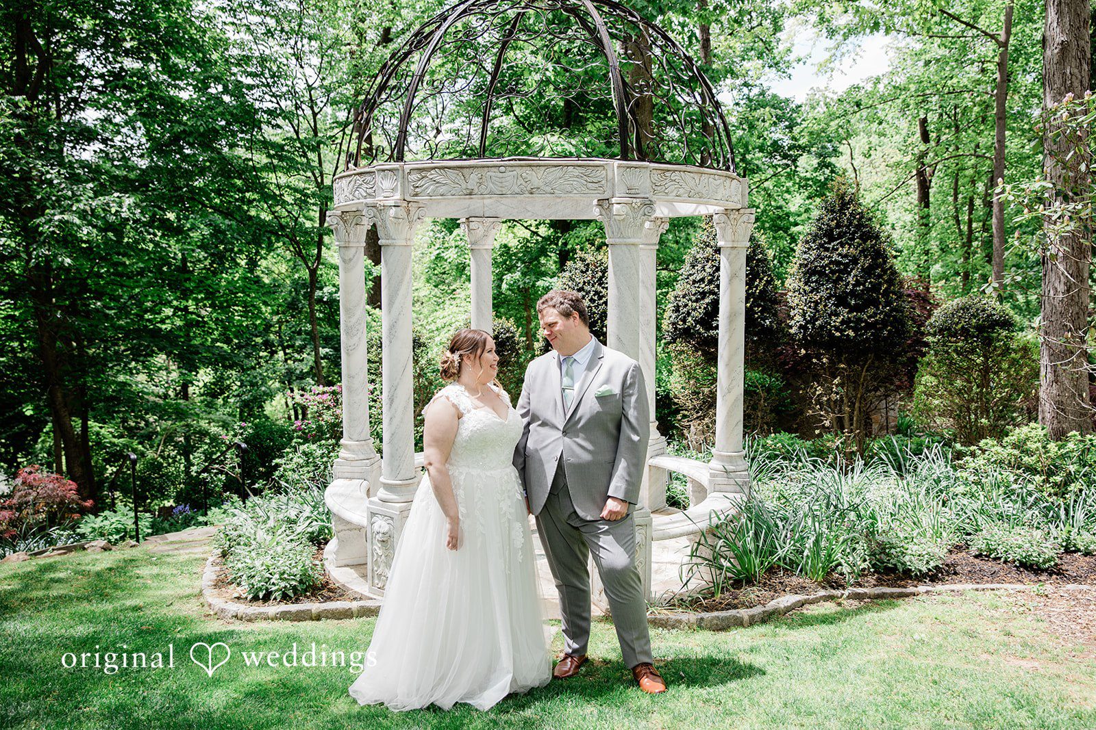 Nicole + Greg A portrait of the couple framed by the beauty of the garden