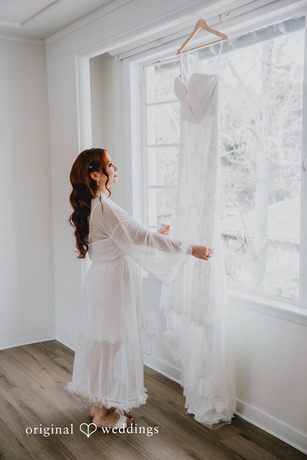 Bride admiring her wedding dress