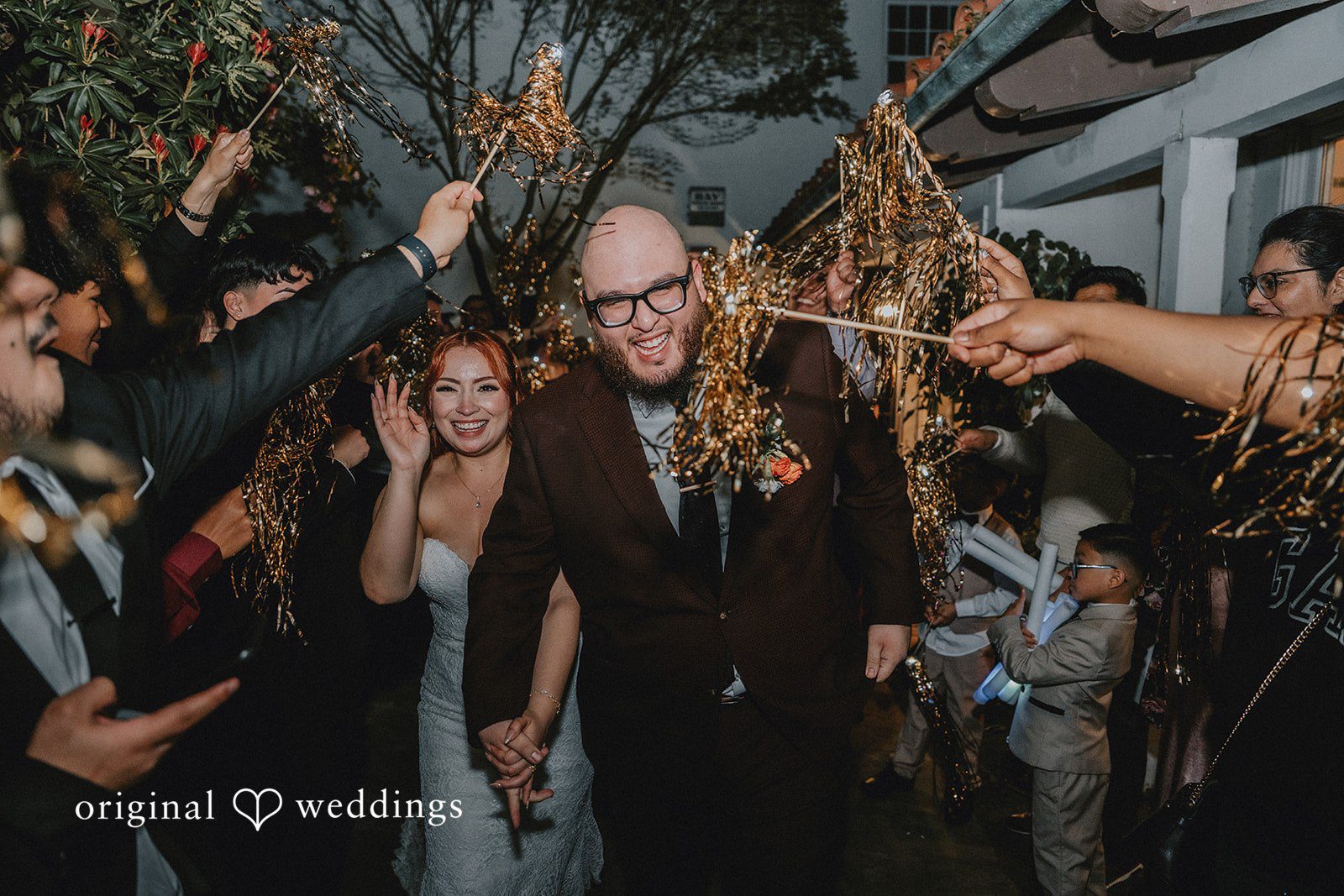 Couple walking through the guests surround them
