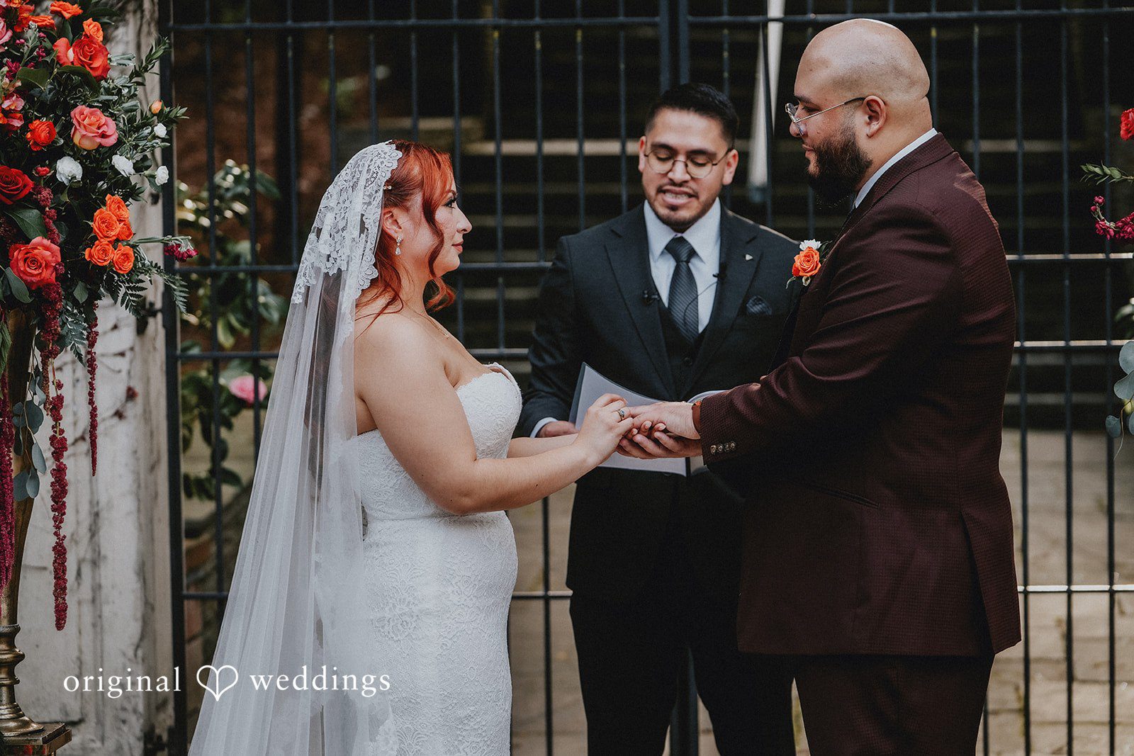 Couple exchanging rings before priest
