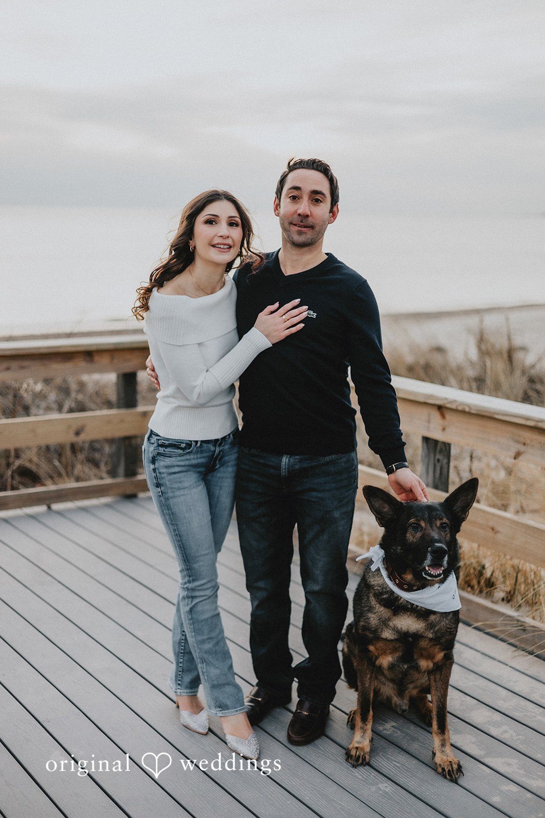 A portrait of the couple and their pup