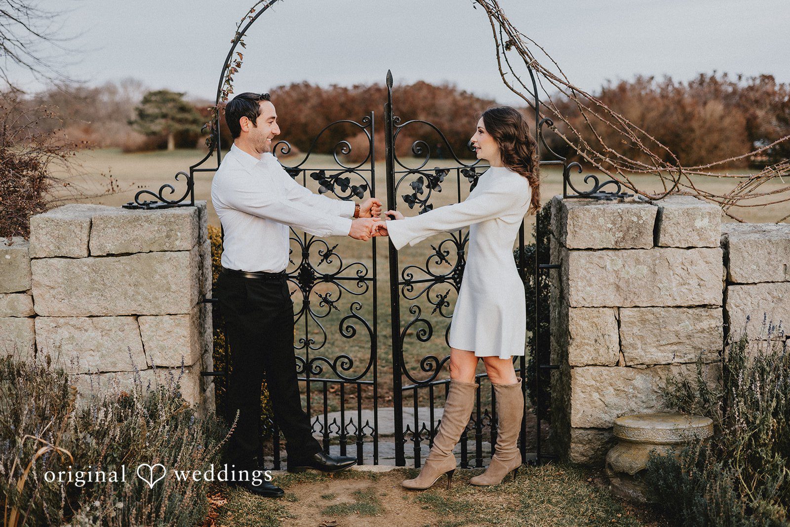 A portrait of the couple by the stone patio gate