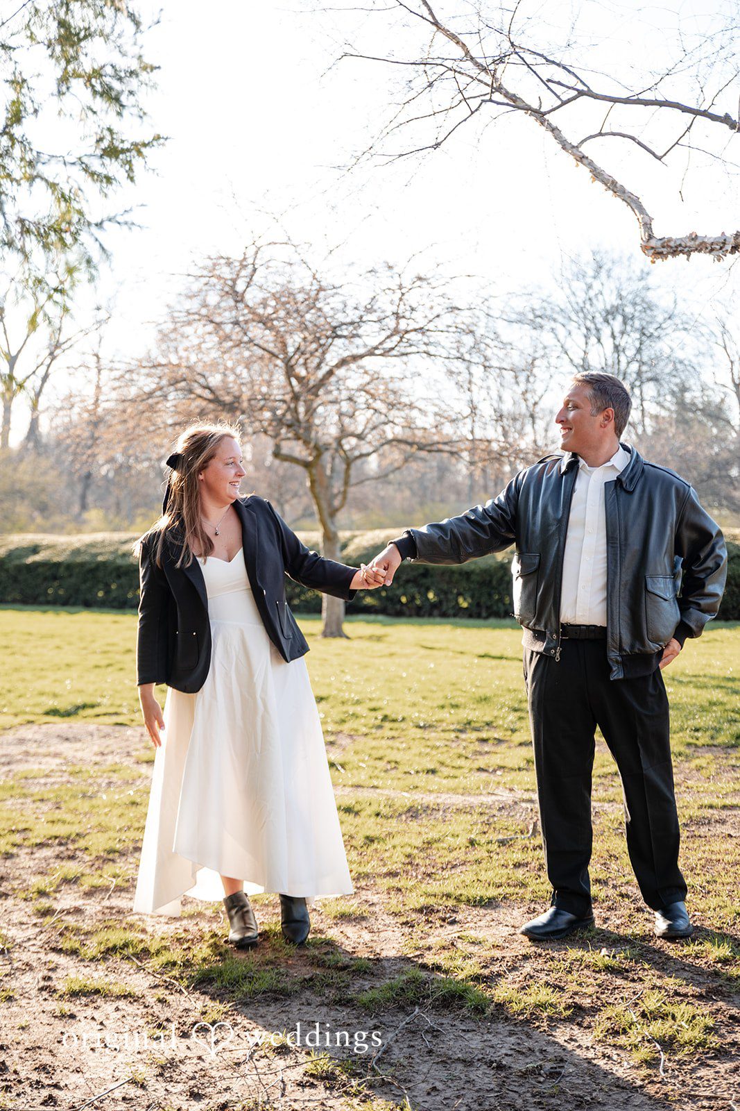 Romantic couple holding hands and looking at each other during engagement session
