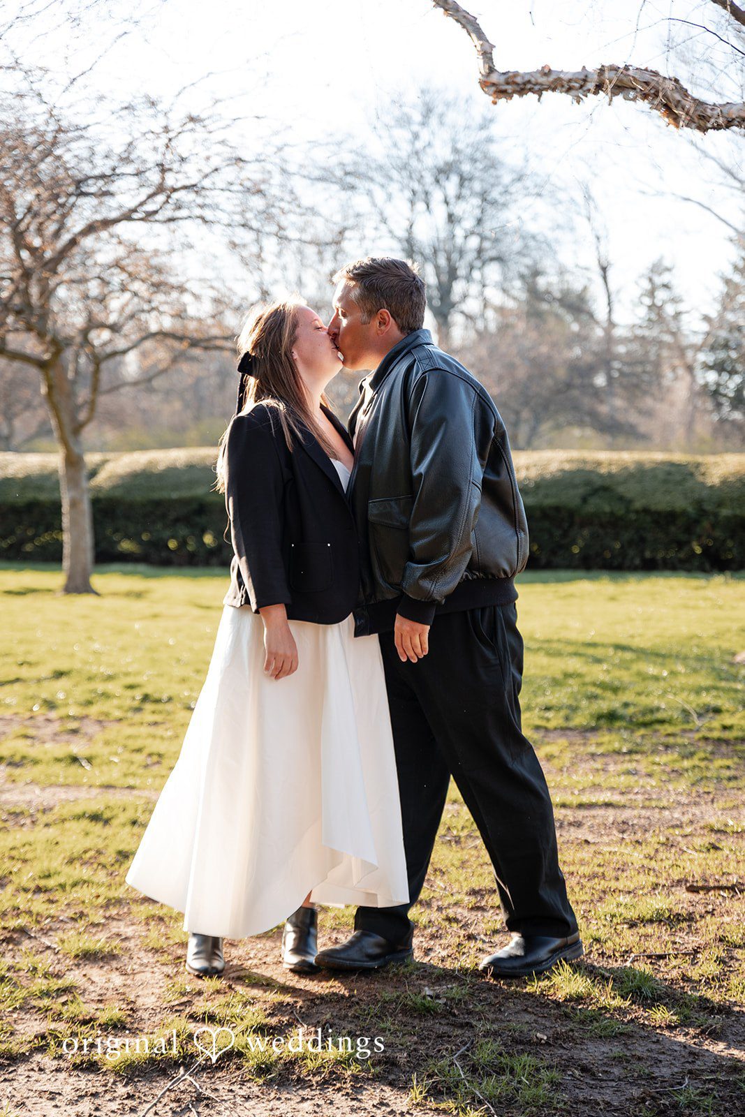 Romantic couple kissing during engagement session at Holcomb Gardens