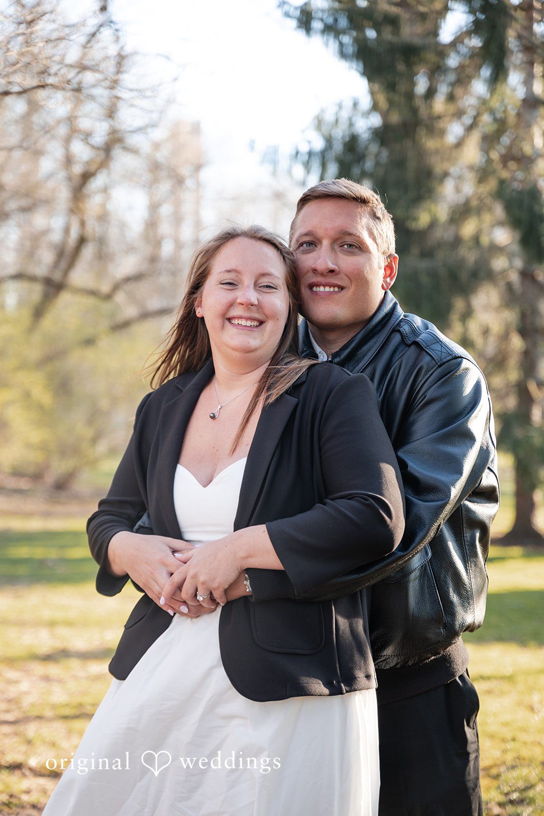 Emotional couple pose with back hug and natural forward look at Holcomb Gardens