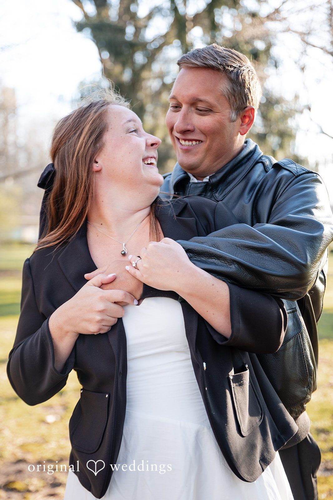 Romantic couple looking at each other and smiling during engagement session