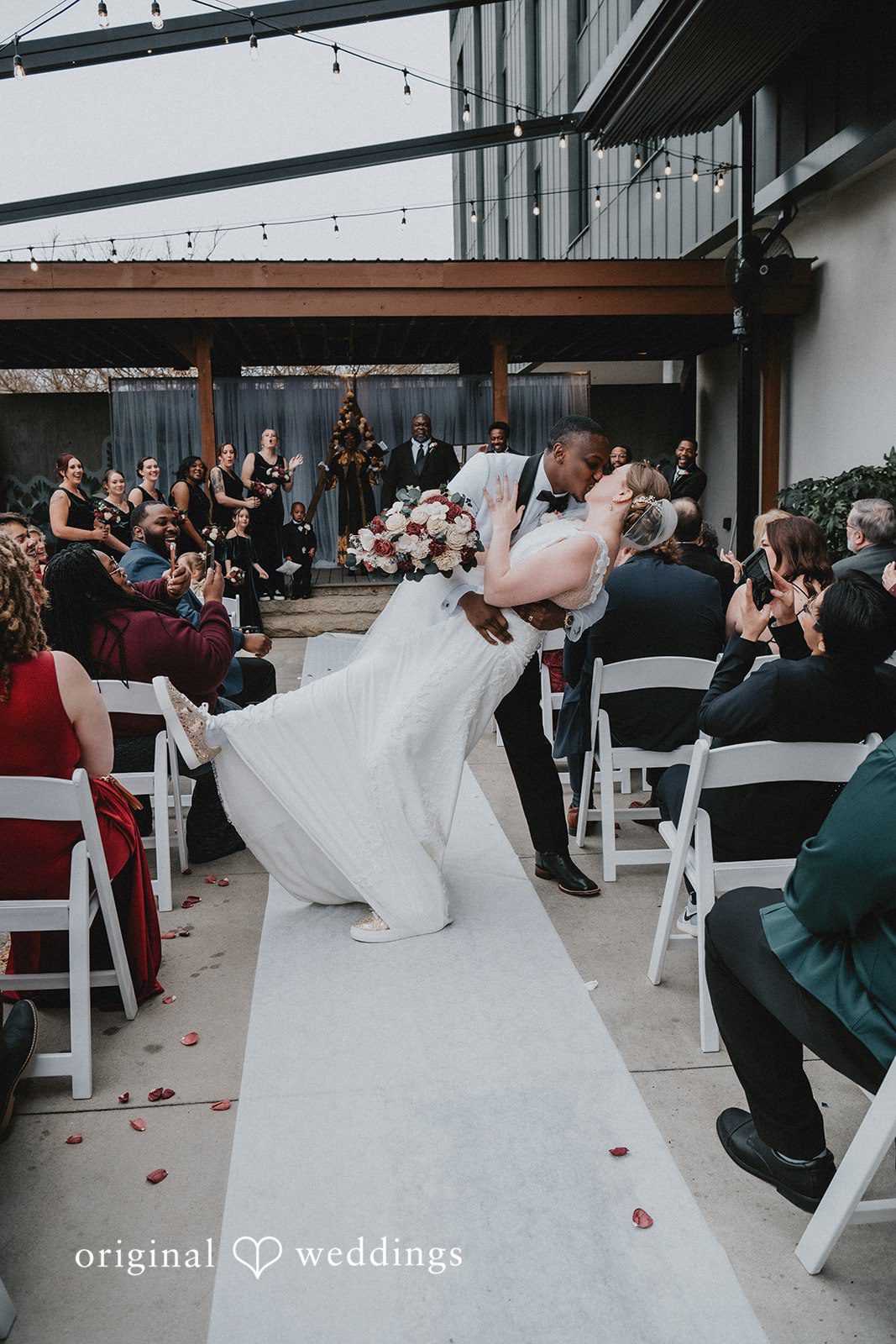 The couple sharing a kiss while walking