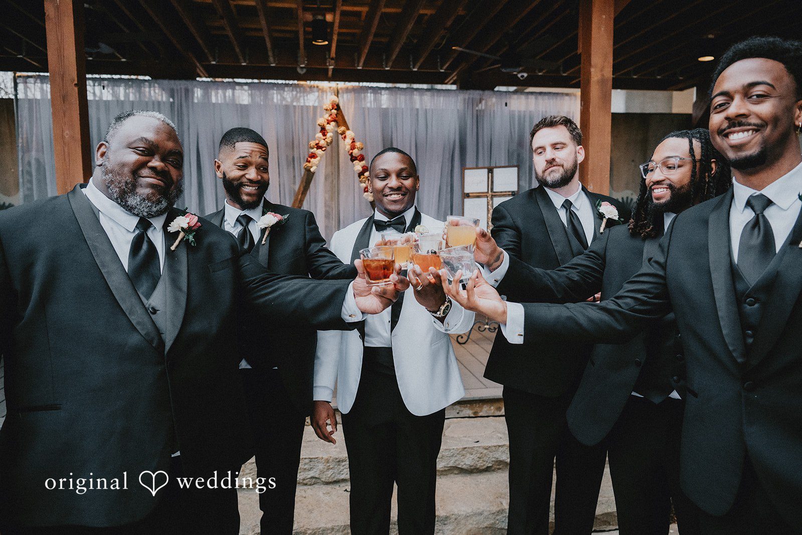 Groom with groomsmen in dark suits posing together