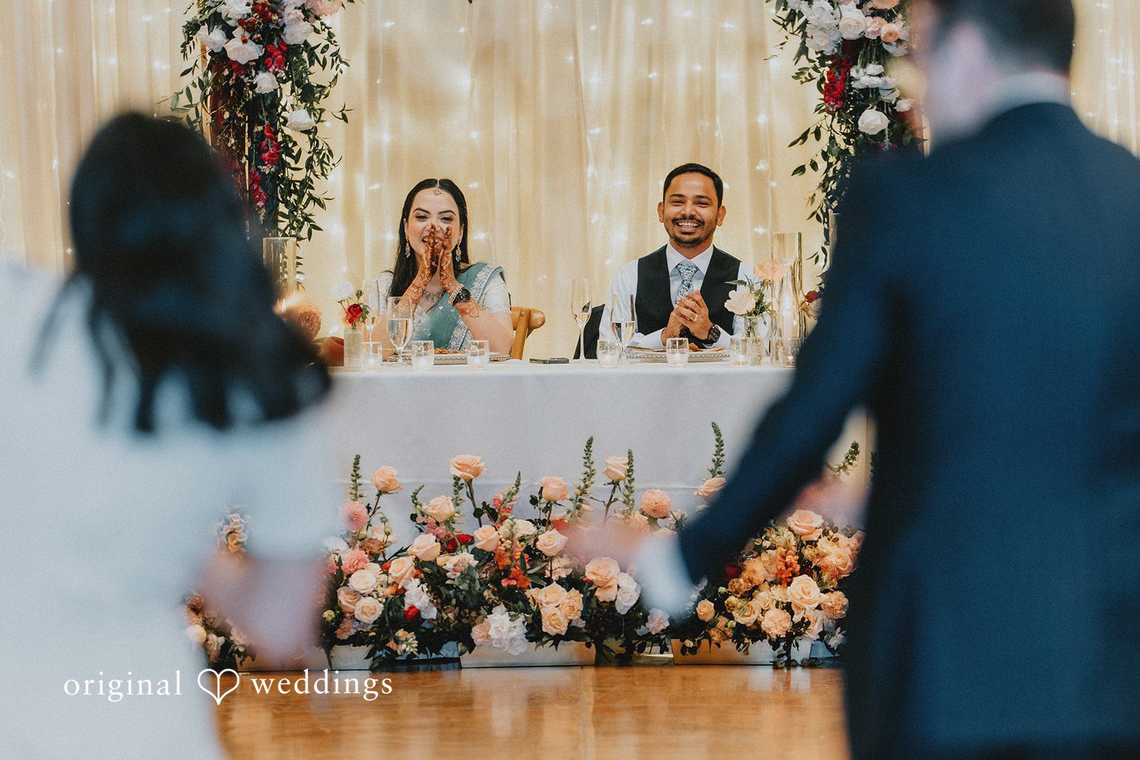 Chandrakant + Sumbul Bride and groom clapping while guests dance during the reception