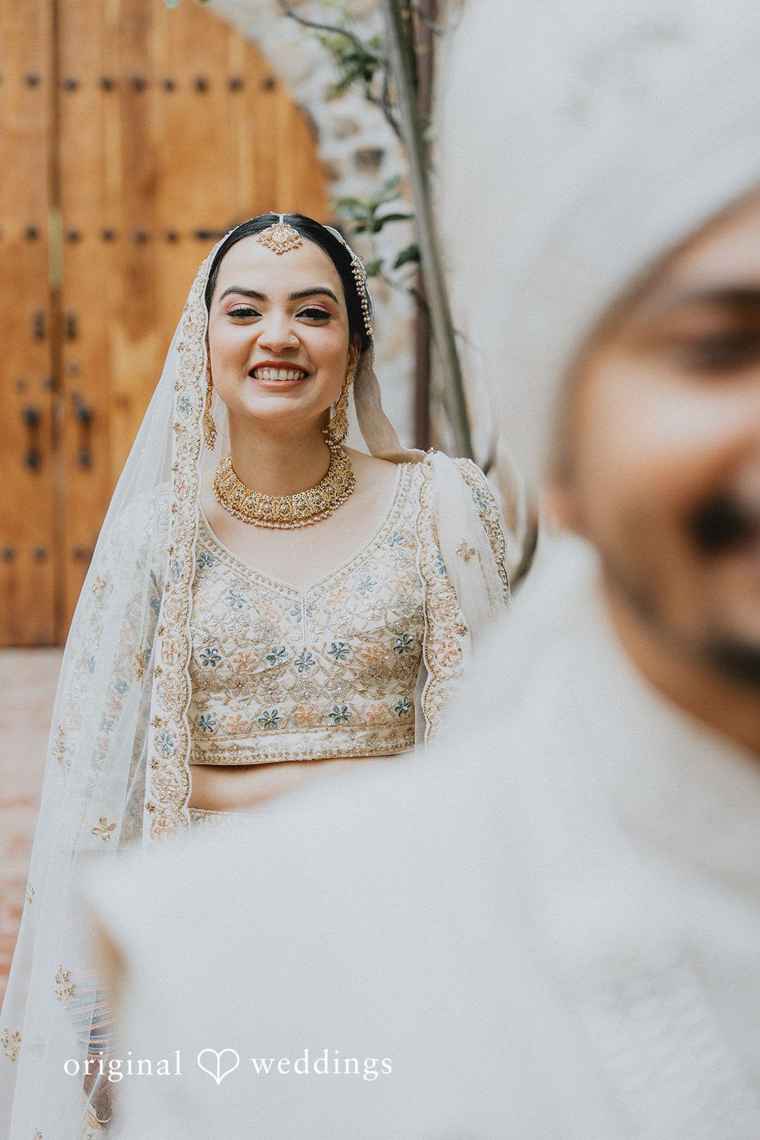 Chandrakant + Sumbul Groom standing with his back turned as the bride approaches